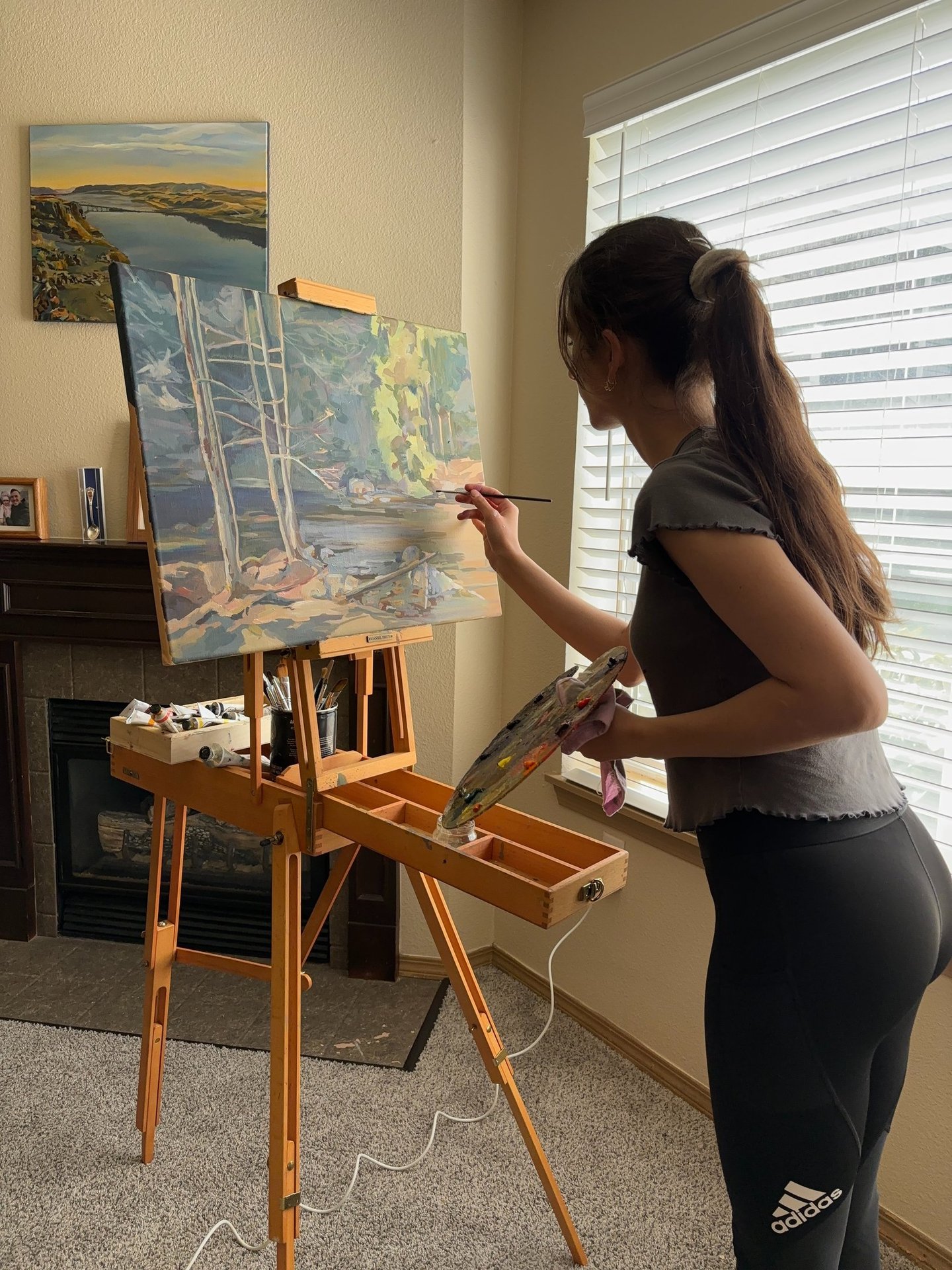 Angela Moiseieva at work on Nature’s Whisper 18 × 24 inches, an original forest oil painting