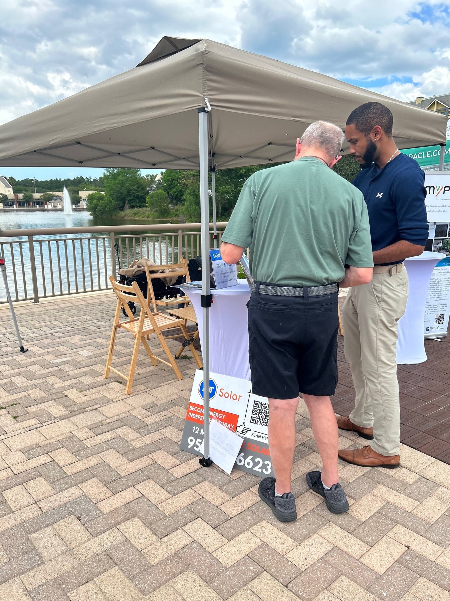 a man and a consultant standing in front of a tent