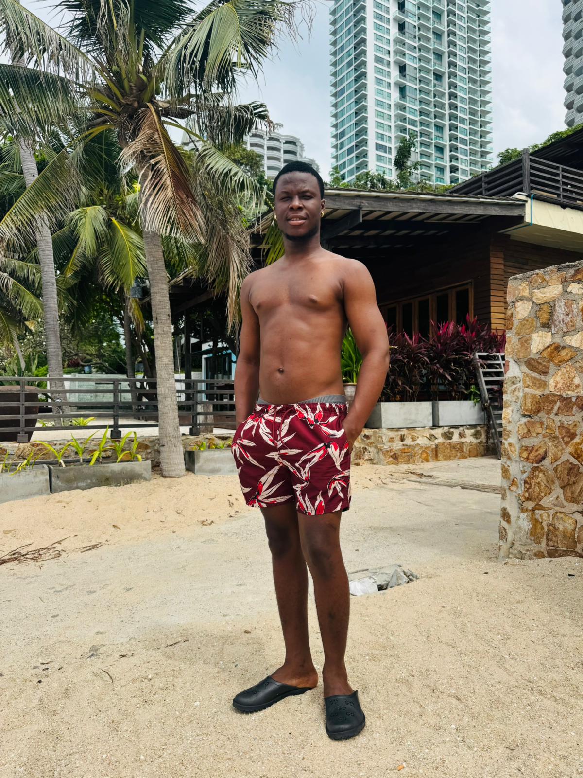 man wearing red and white shorts with his hands in his pockets