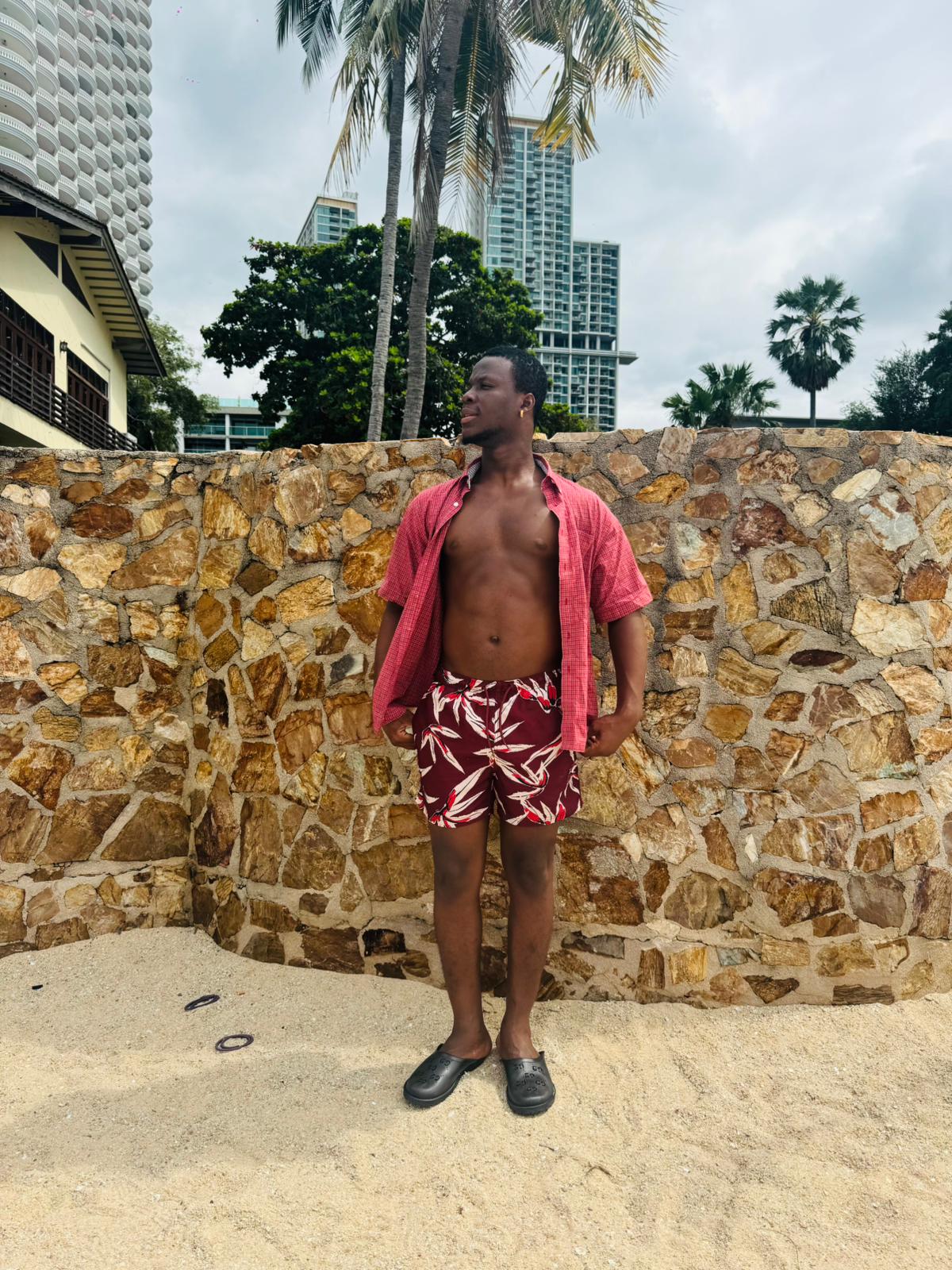 man wearing red and white shorts and red short sleeve shirt with buttons open