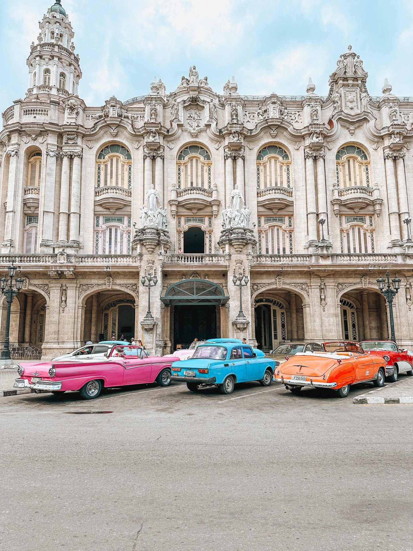 Classic cars parked in front of a building in Havana, Cuba