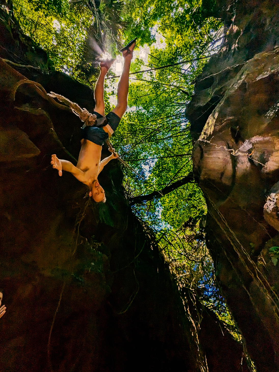 a man is doing a trick on a canyon rock climbing