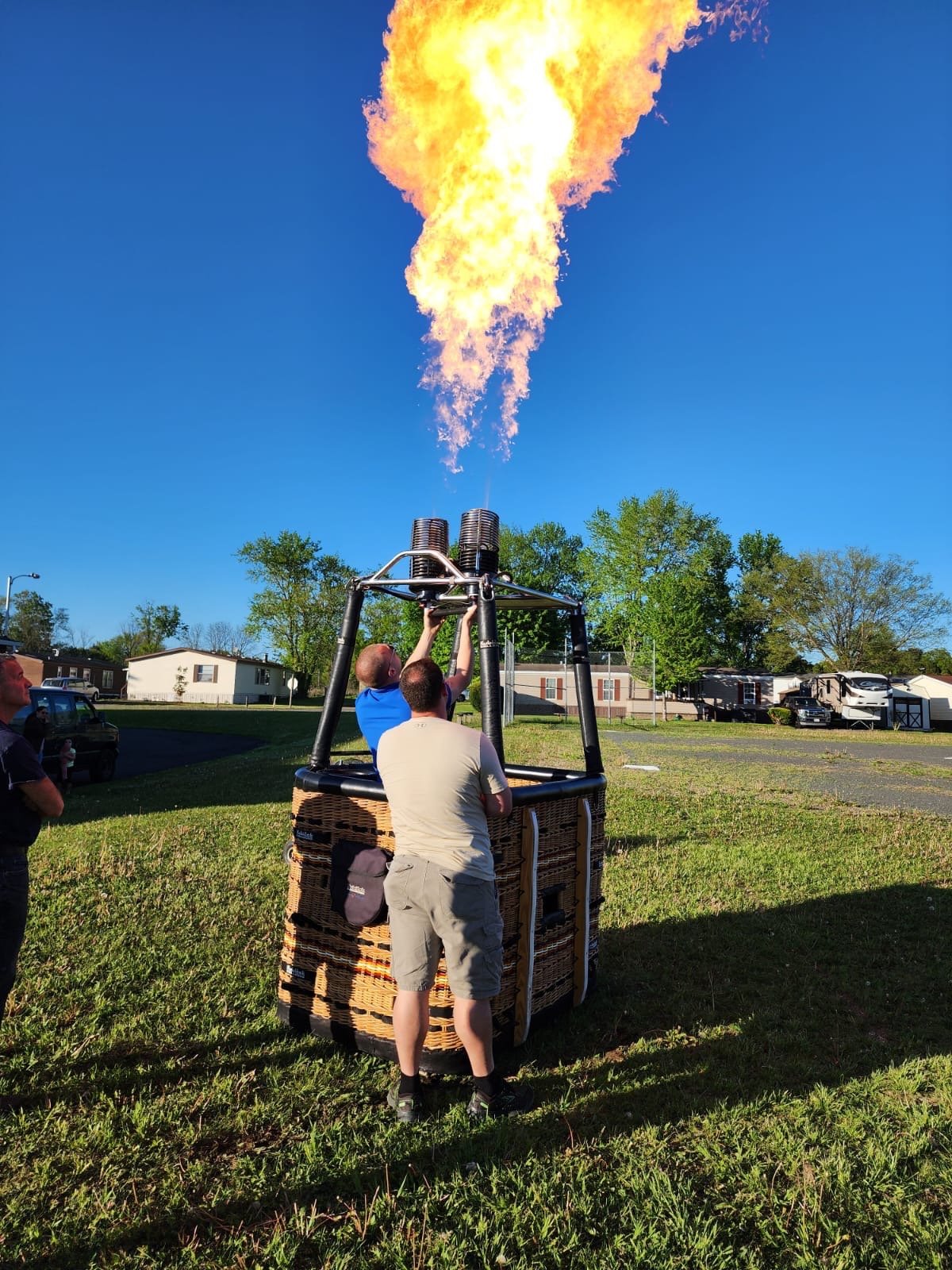 a man is standing in front of a hot air balloon