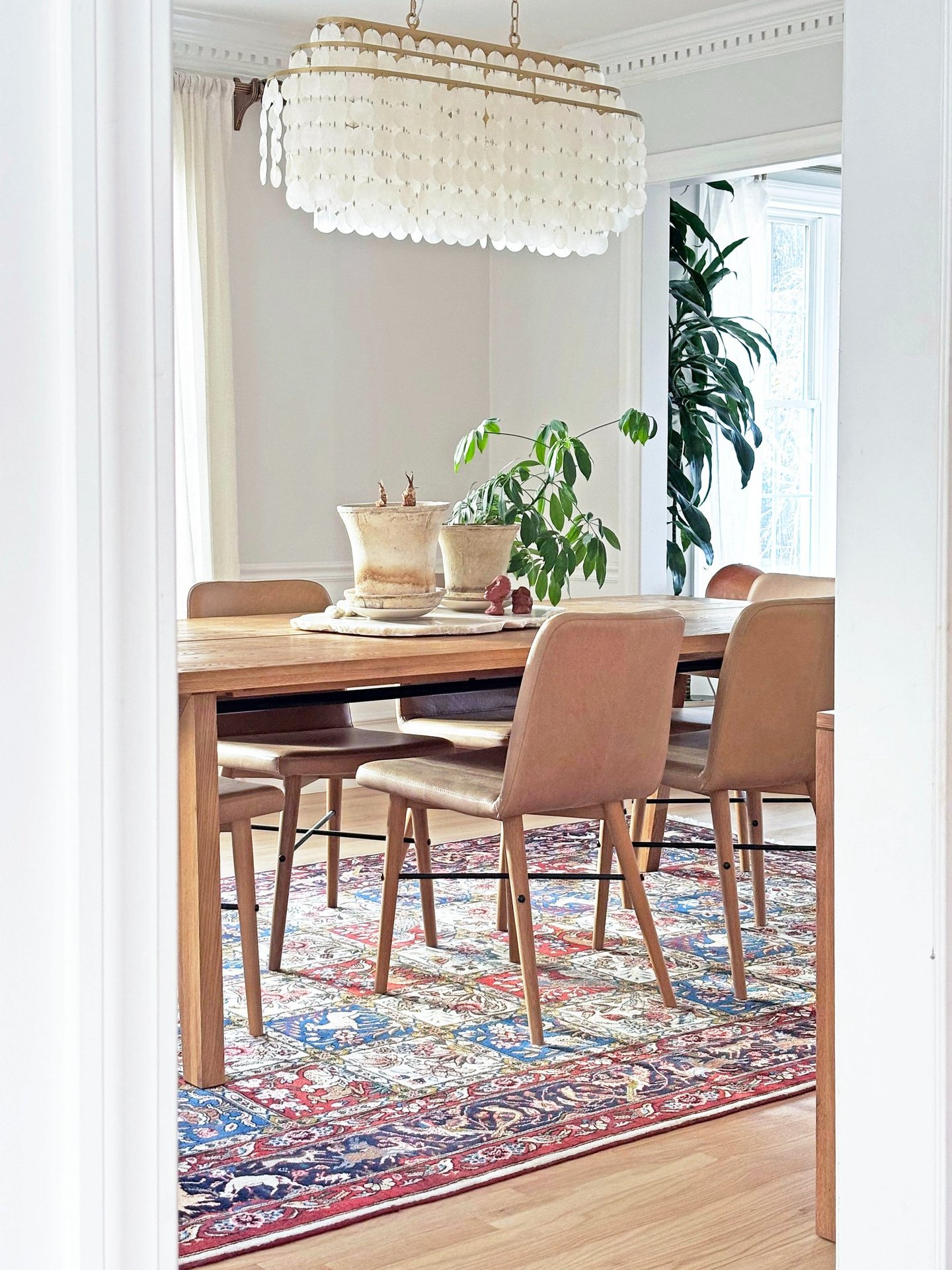Dining room, capiz chandelier, antique Persian rug, Article oak table, interior renovation Lancaster MA, Erica Fossati Design