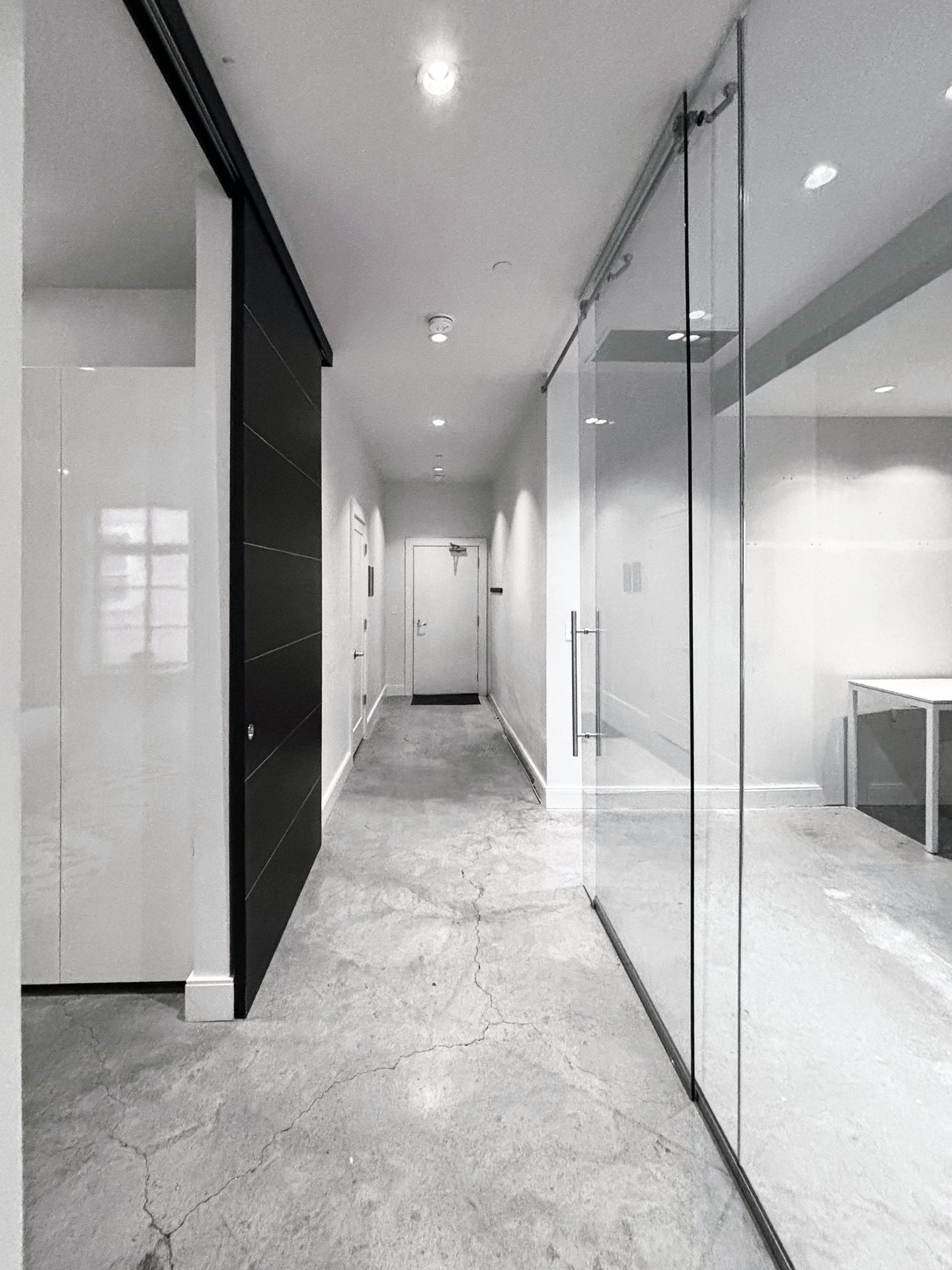 Minimal contemporary condo in progress, concrete floors, glass partition, South End Boston, Erica Fossati Design