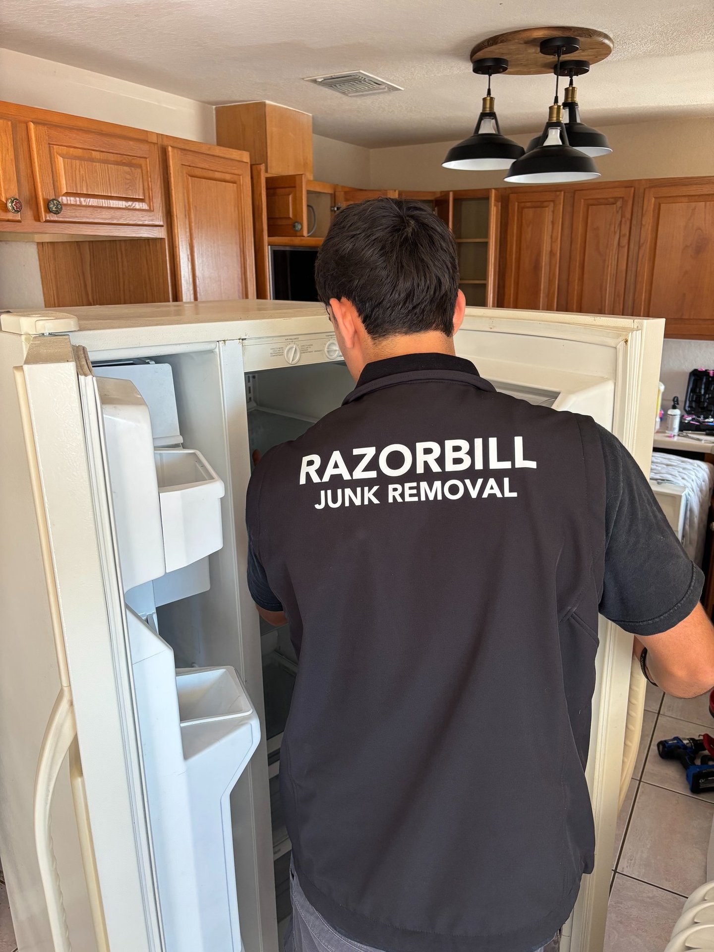 Razorbill Junk Removal removing an old refrigerator in San Antonio