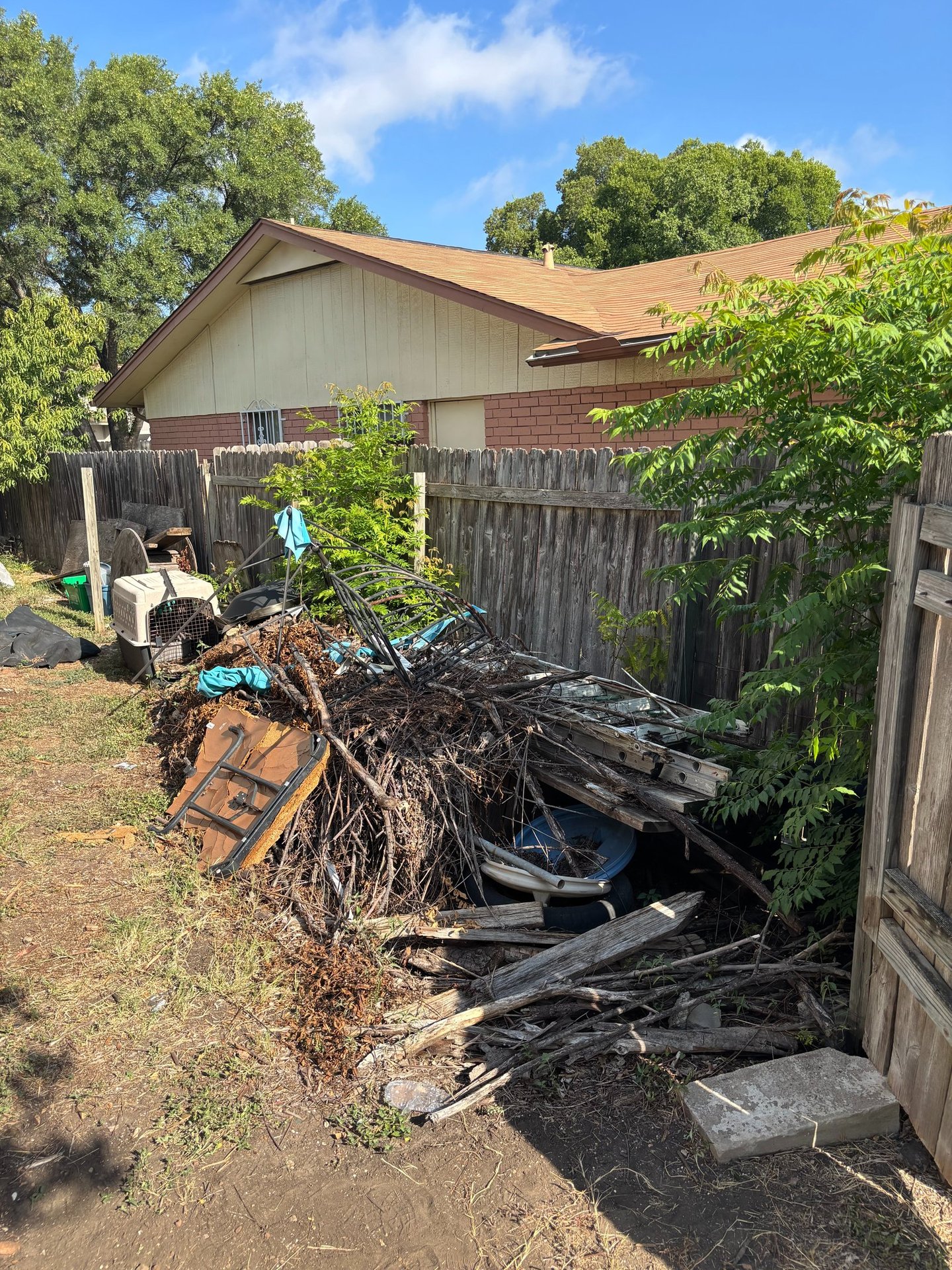 backyard in fair oaks ranch full of branches and backyard debris