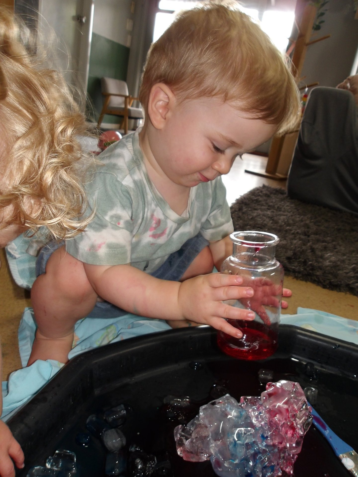 child playing with a jar