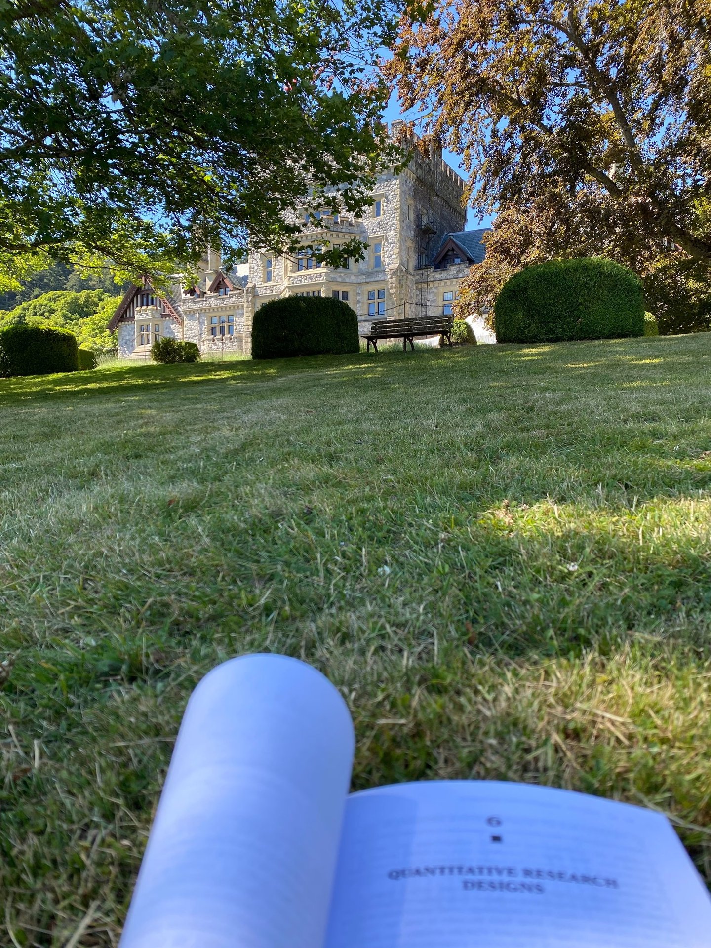 A green lawn with Royal Roads University's Hatley Castle in the background.