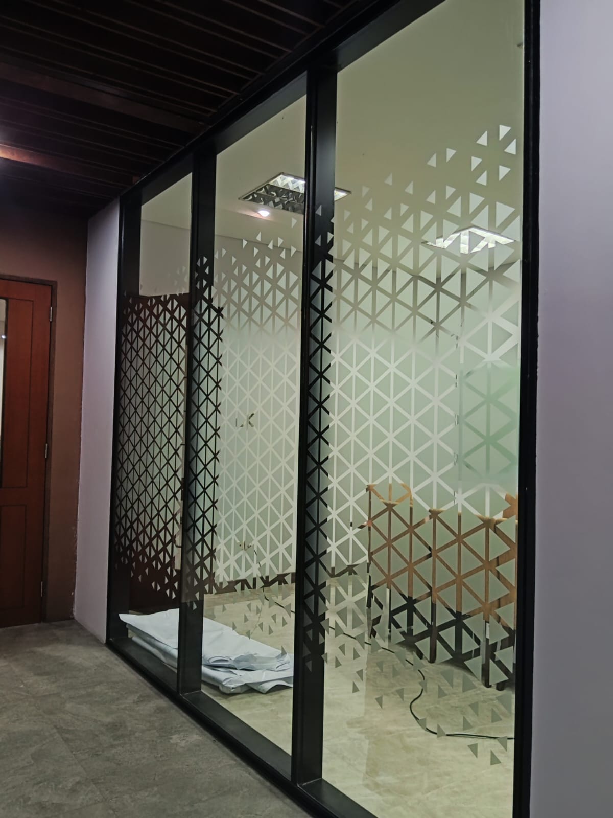 Pemasangan sticker sandblast motif geometris oleh tim AFL di Kantor Pemasaran Citra Gran Cibubur.