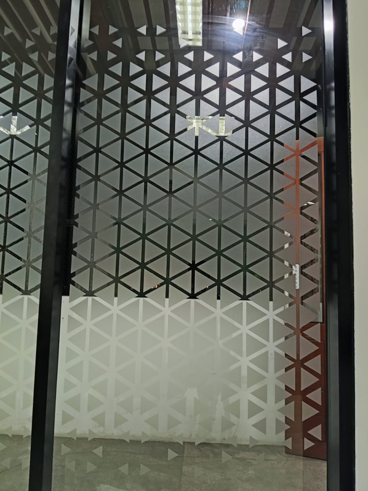 Detail cutting sticker sandblast pattern segitiga pada pintu kaca, dipasang langsung oleh tim AFL.