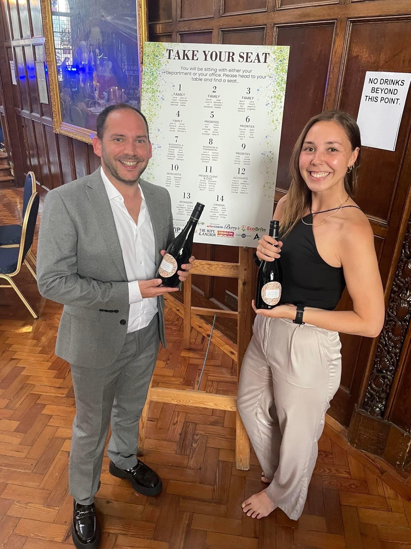 Alex Duffy and Nicola Lashley holding bottles of Prosecco.