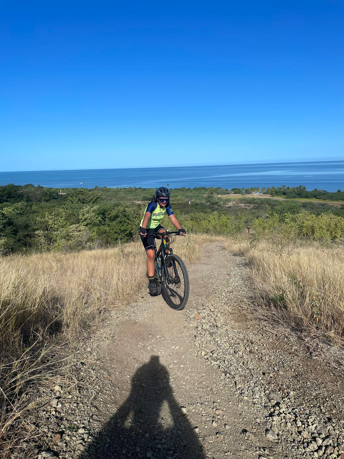 a person riding a bike on a dirt road