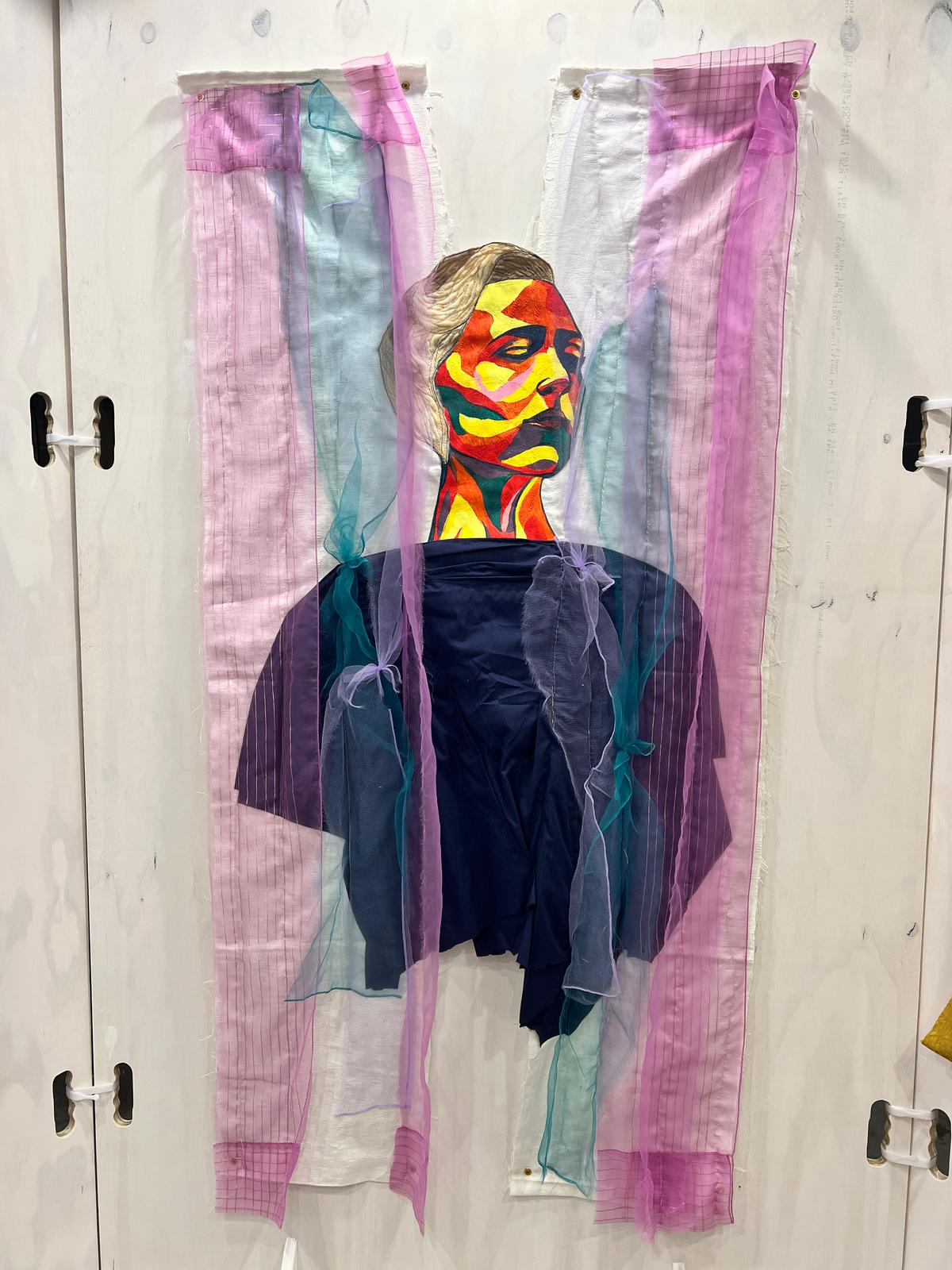 a painting of a woman with a colorful face and fabric draping around her body