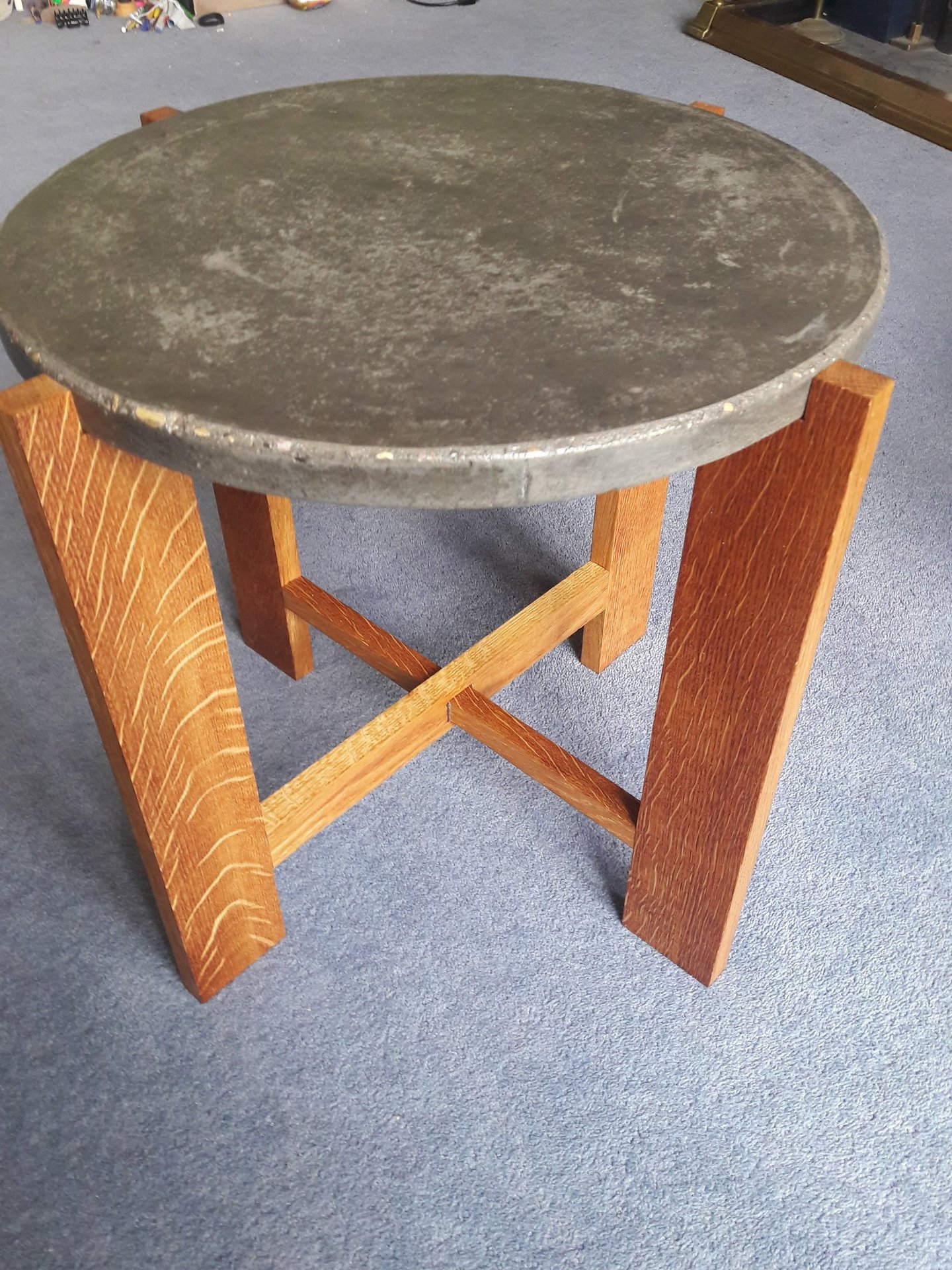 Coffee table made from 4 oak legs with cross pieces topped with a circular concrete top