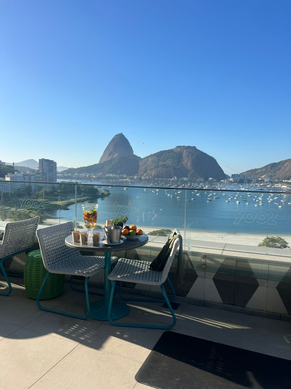 a table with a tray of food and a bowl of fruit