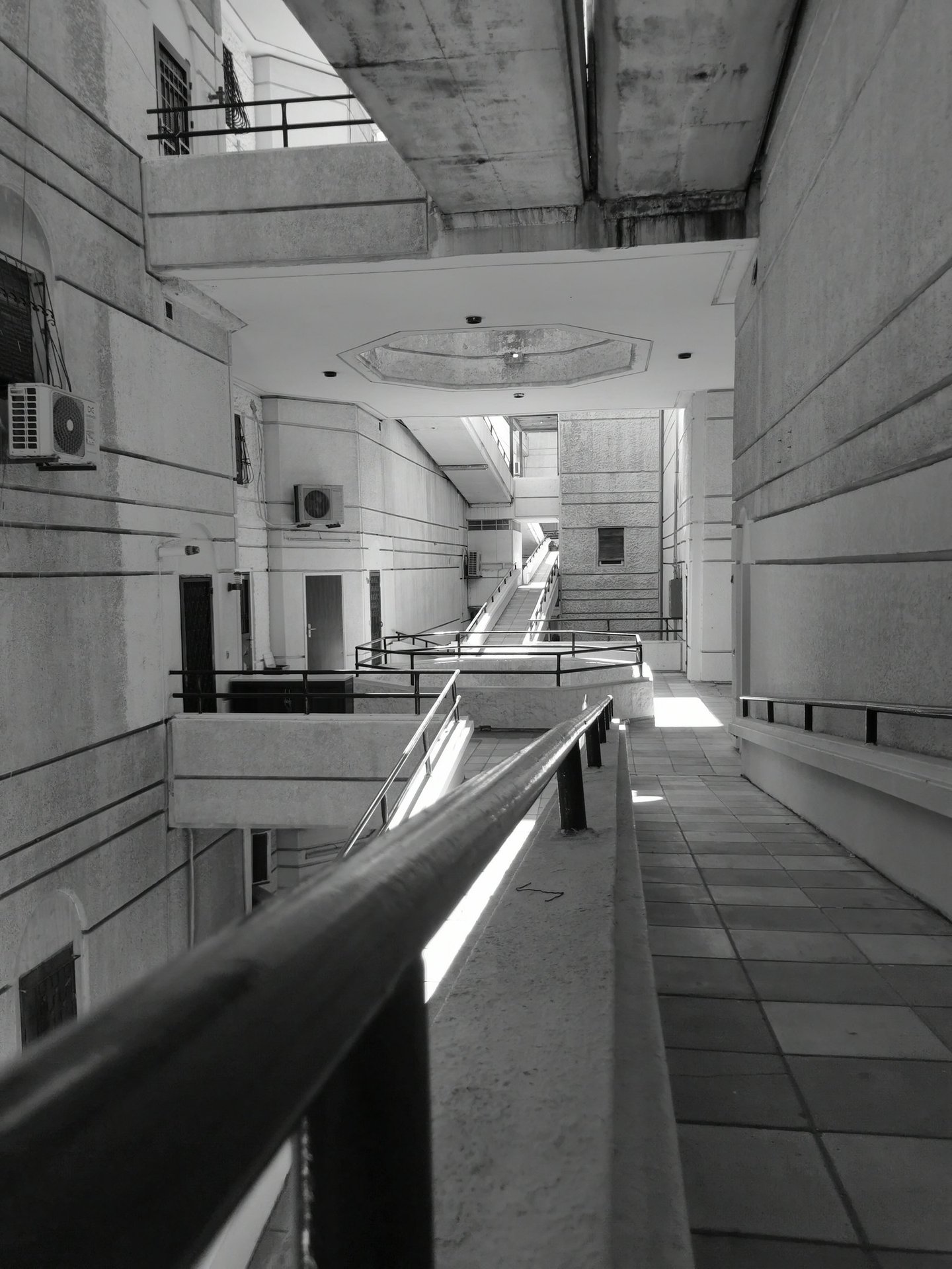Black and white brutalist architecture featuring concrete walkways and communal building design.