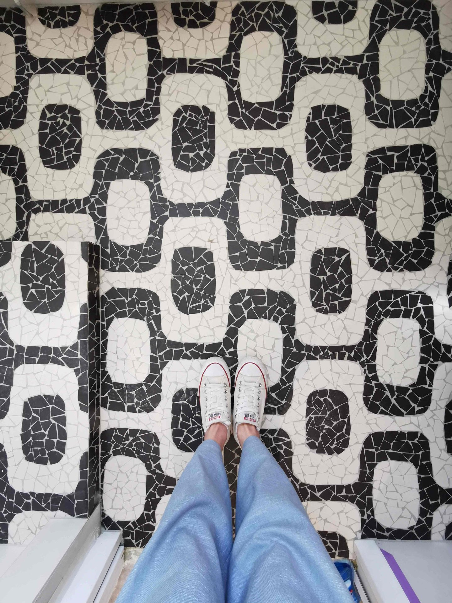 Black and white geometric mosaic tile floor, Ipanema floor style.
