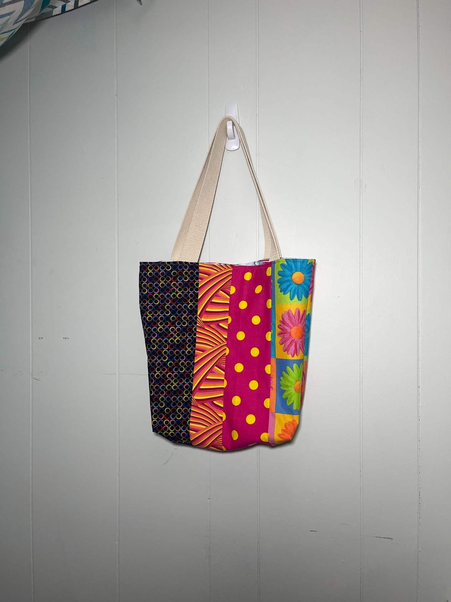  a colorful patchwork bag hanging on a wall