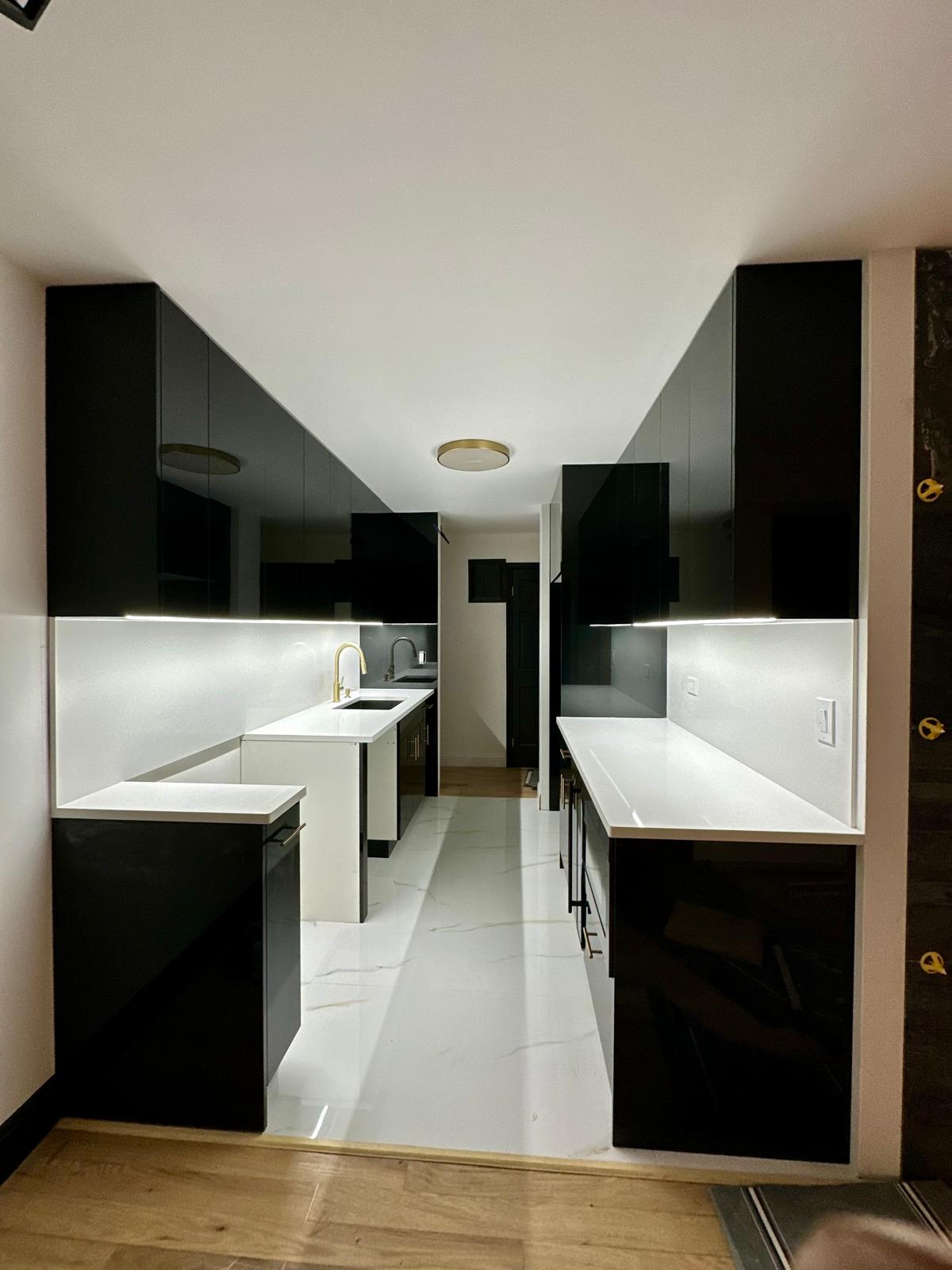 a kitchen with a long counter top and a sink