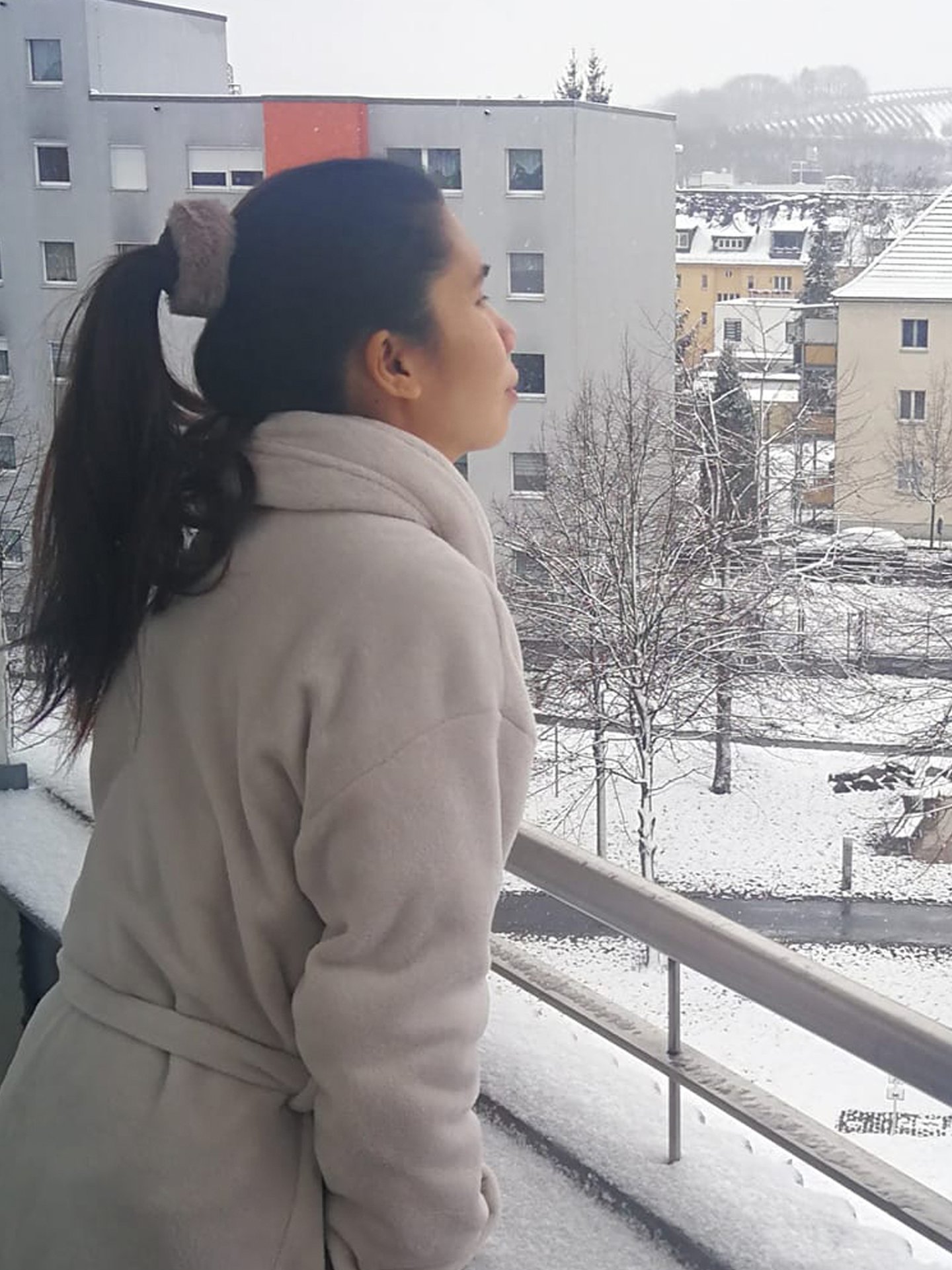 a woman in a coat and a coat over her head