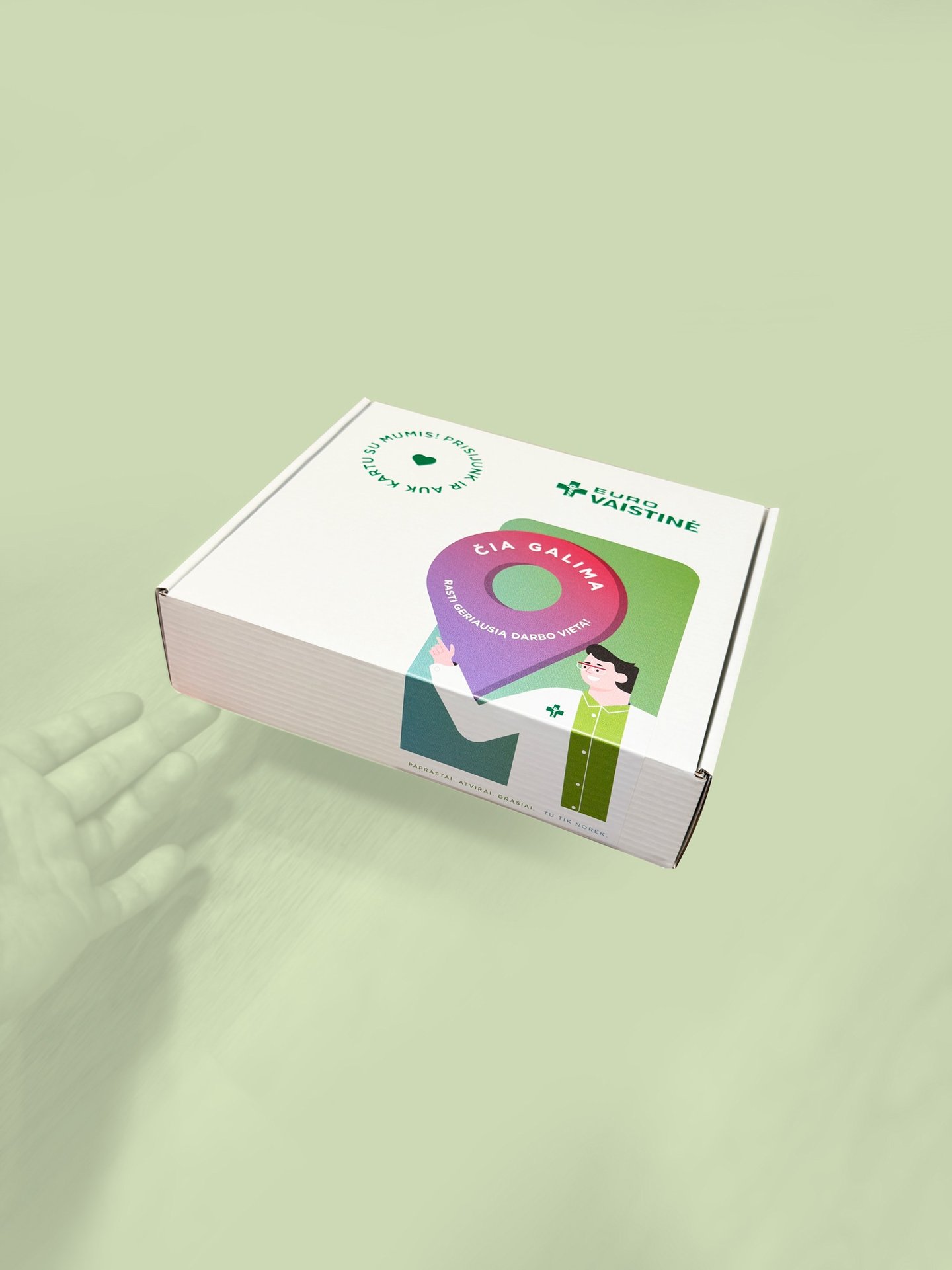 Euro Vaistine branded white cardboard box with colorful pharmacy workplace graphics on a light green background.