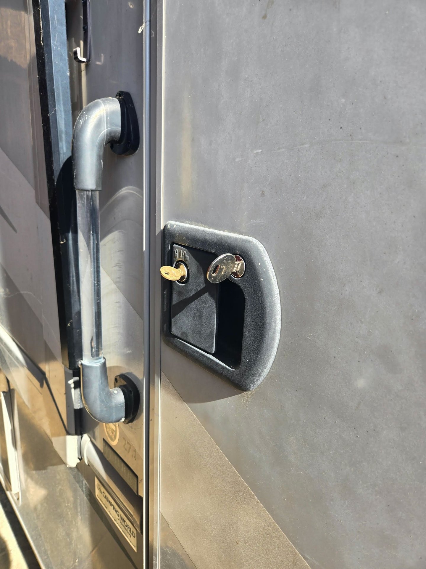 RV entry door handle and lock with key inserted