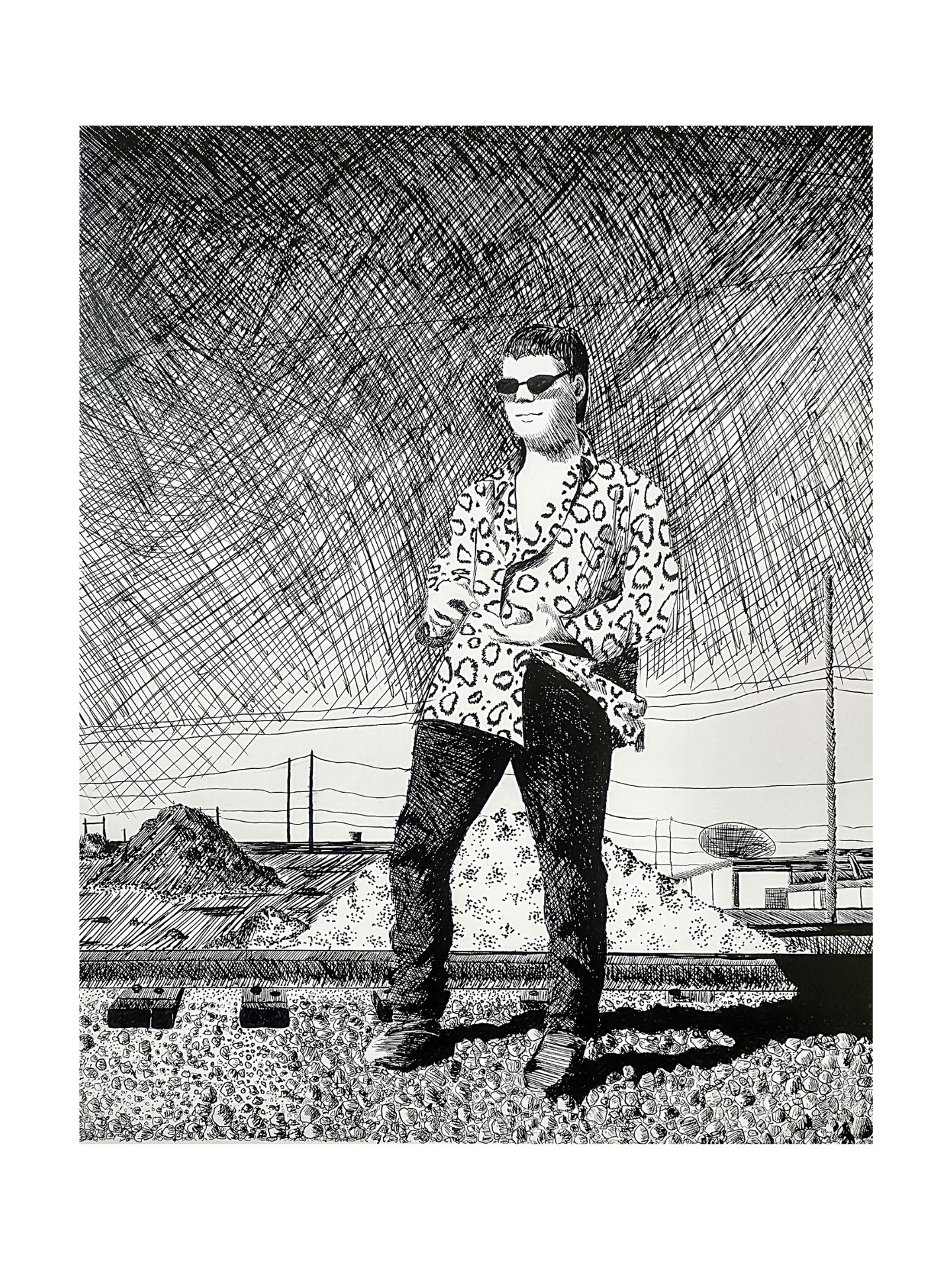 a man in sunglasses and a shirt is standing near train tracks