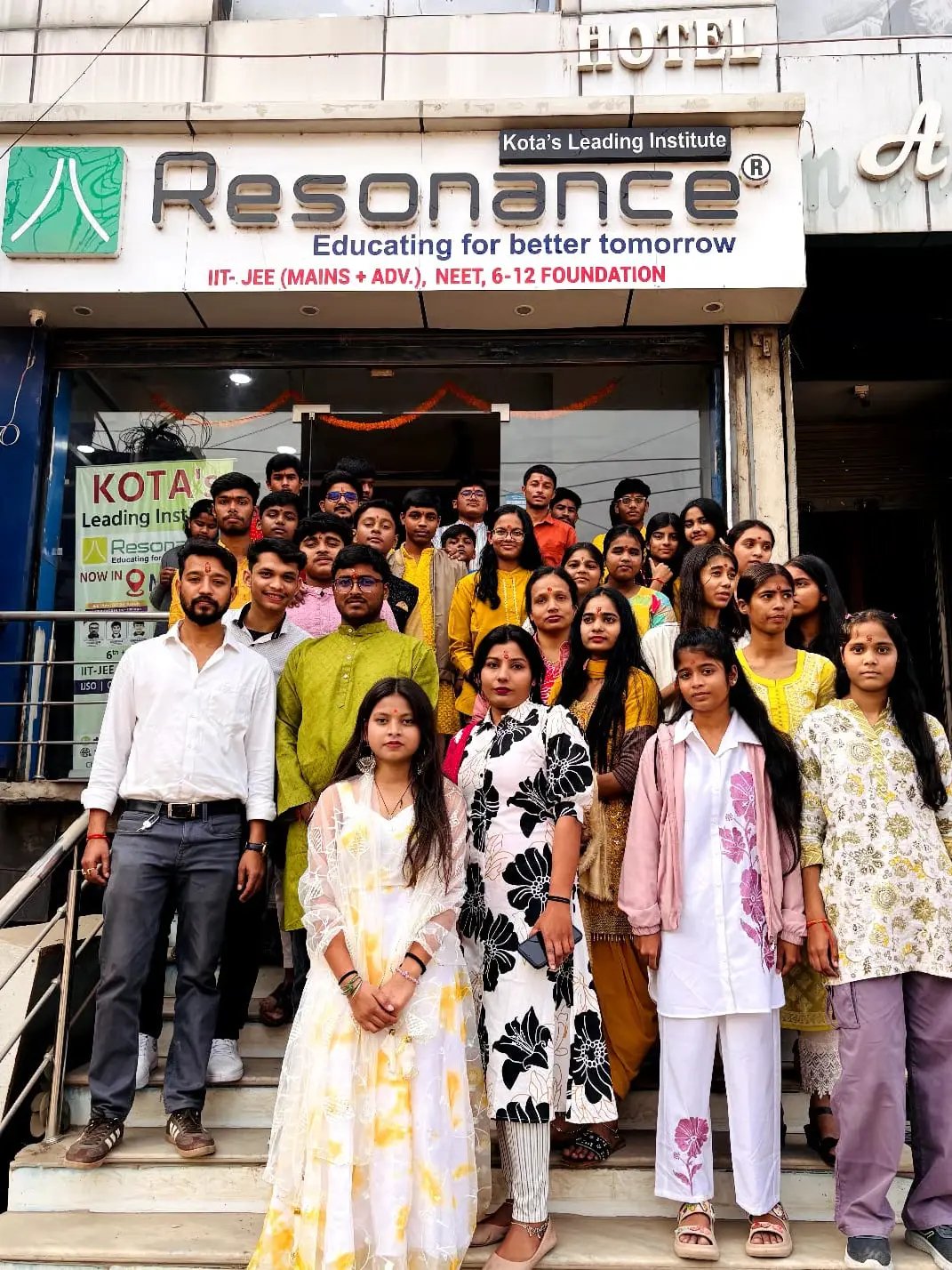 Students and teachers posing at Resonance Kota coaching institute for IIT-JEE and NEET preparation.