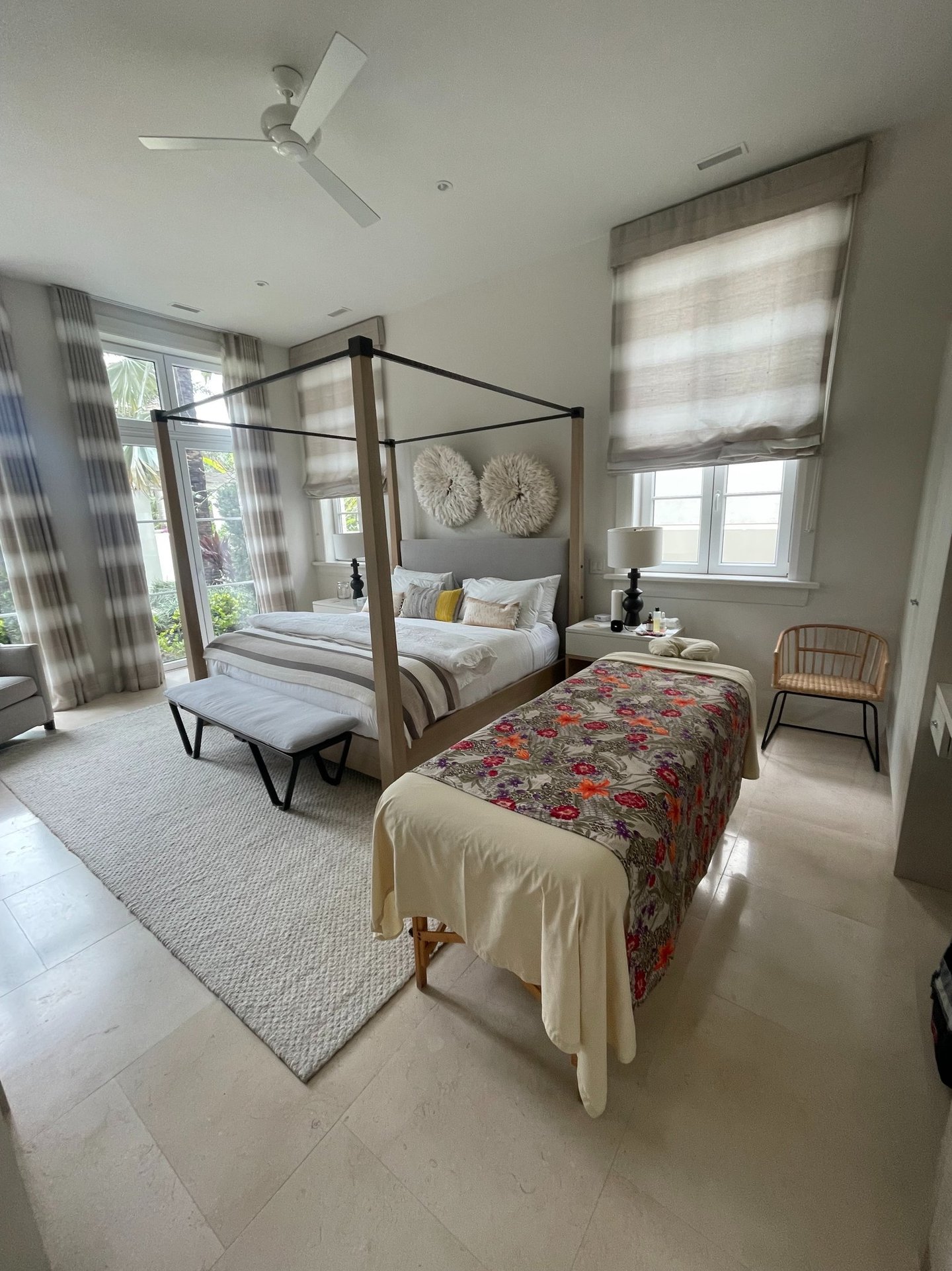 a bedroom with a canopy bed and a massages by sophia massage bed