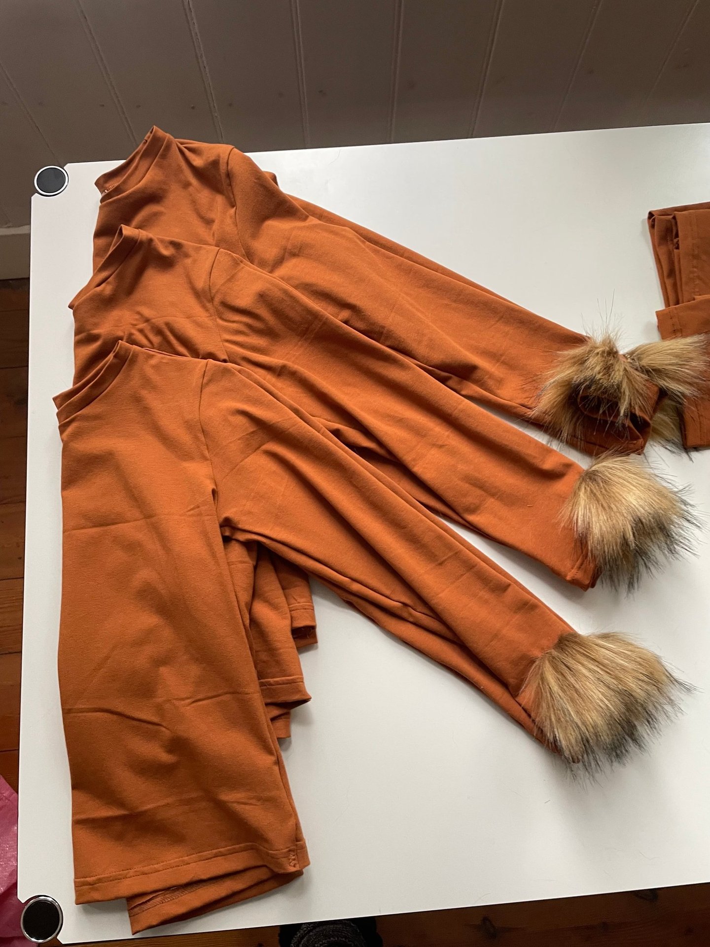 Lion long-sleeve shirts with faux fur cuffs.