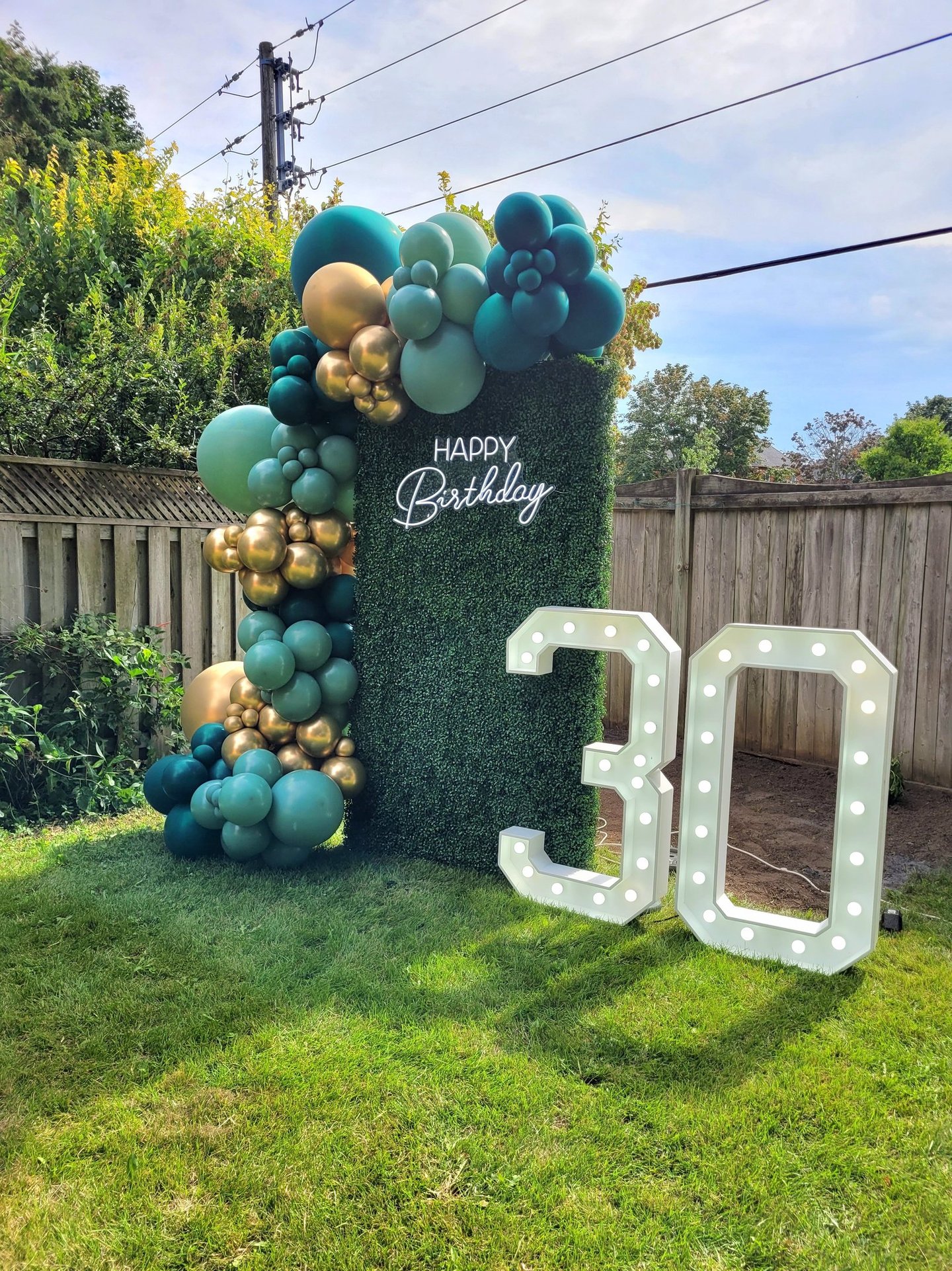 30th marquee with green & gold balloons