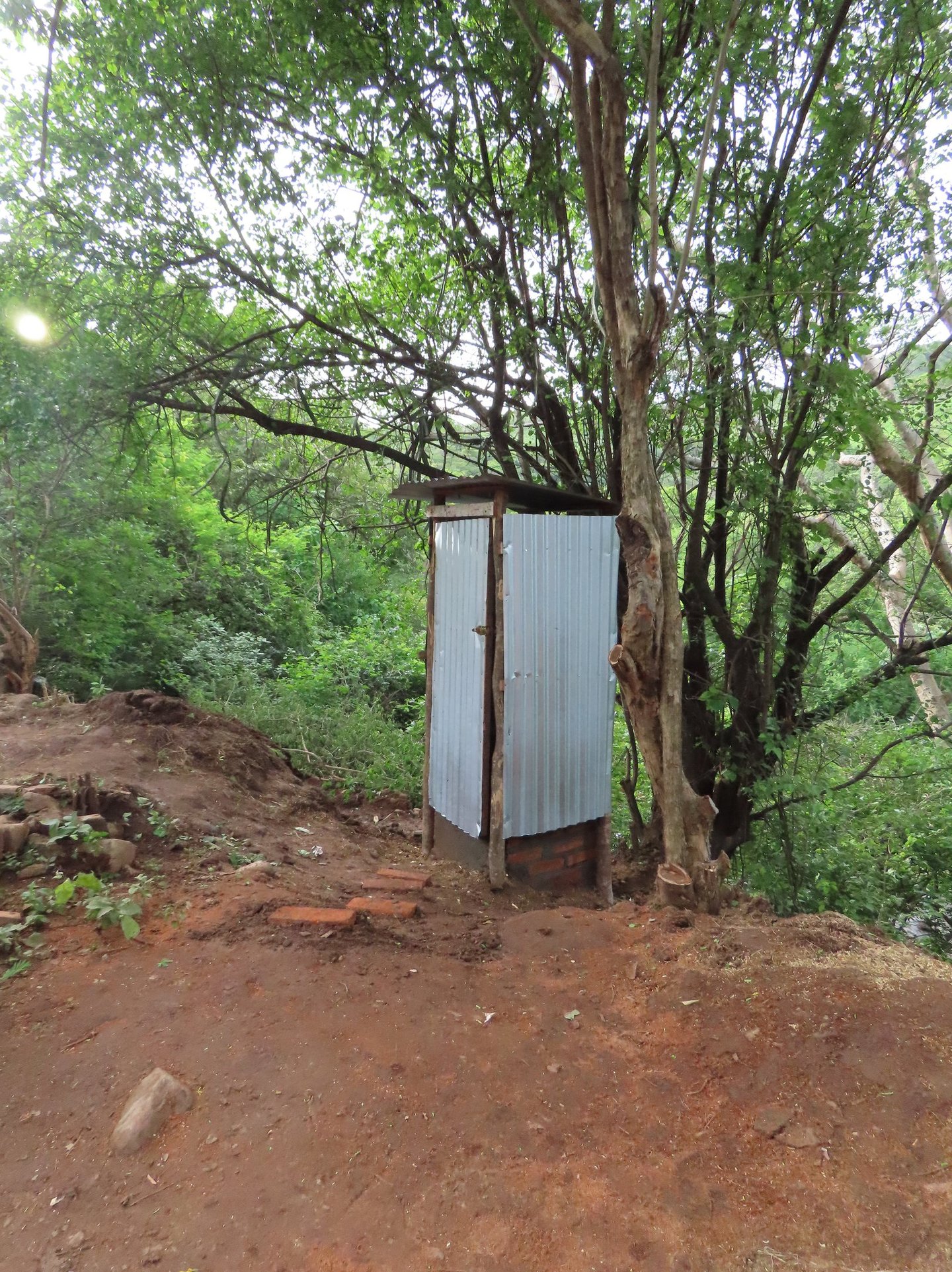 Outhouse in remote landscape used to increase hygiene and sanitation.
