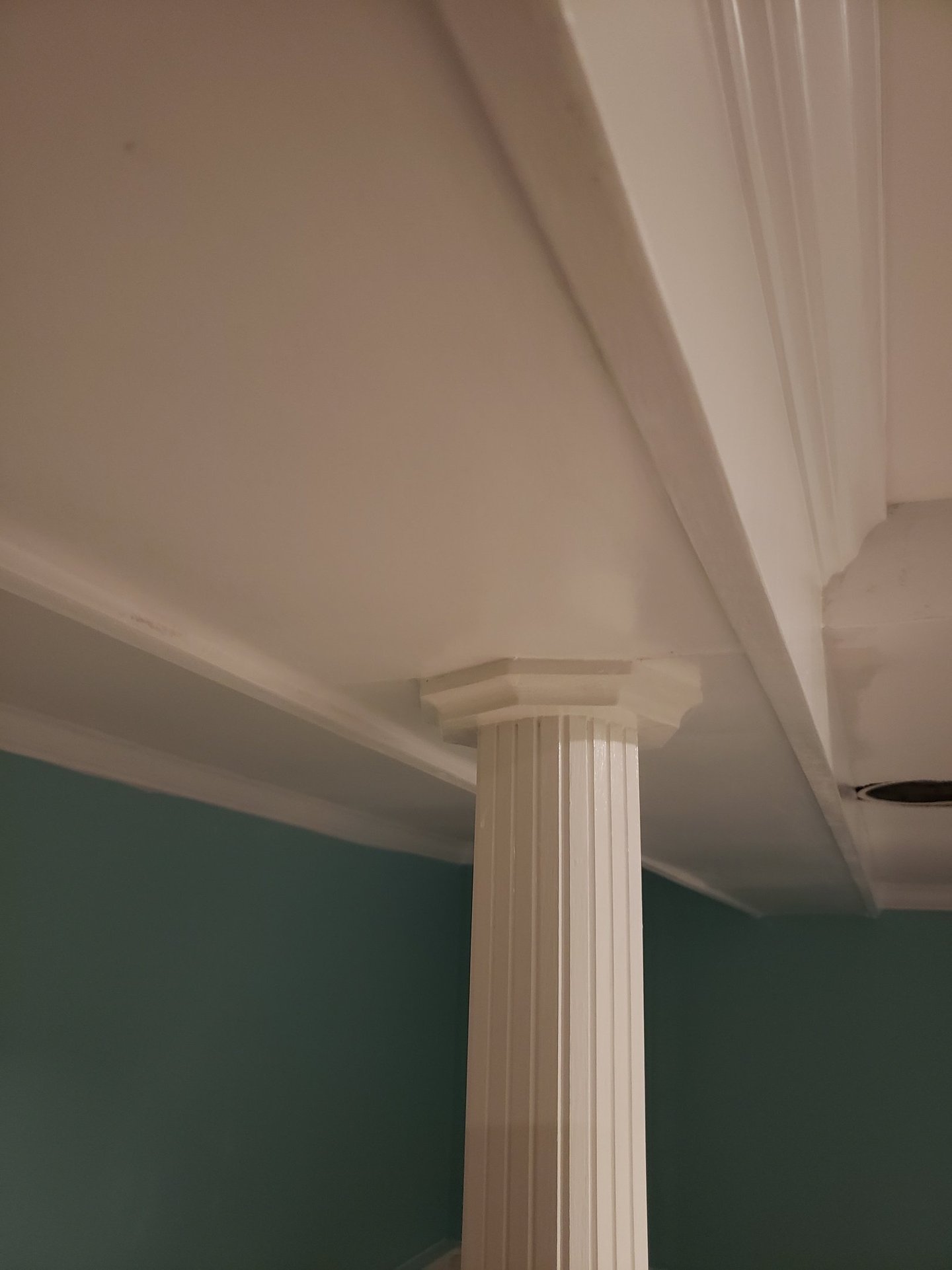 a column with a ceiling fan and a fan