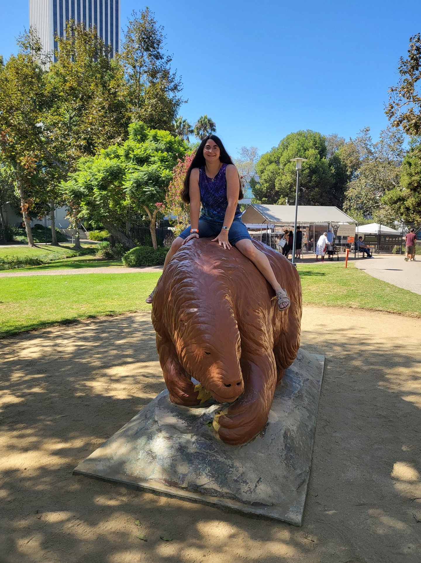 Andrielle riding giant ground sloth statue