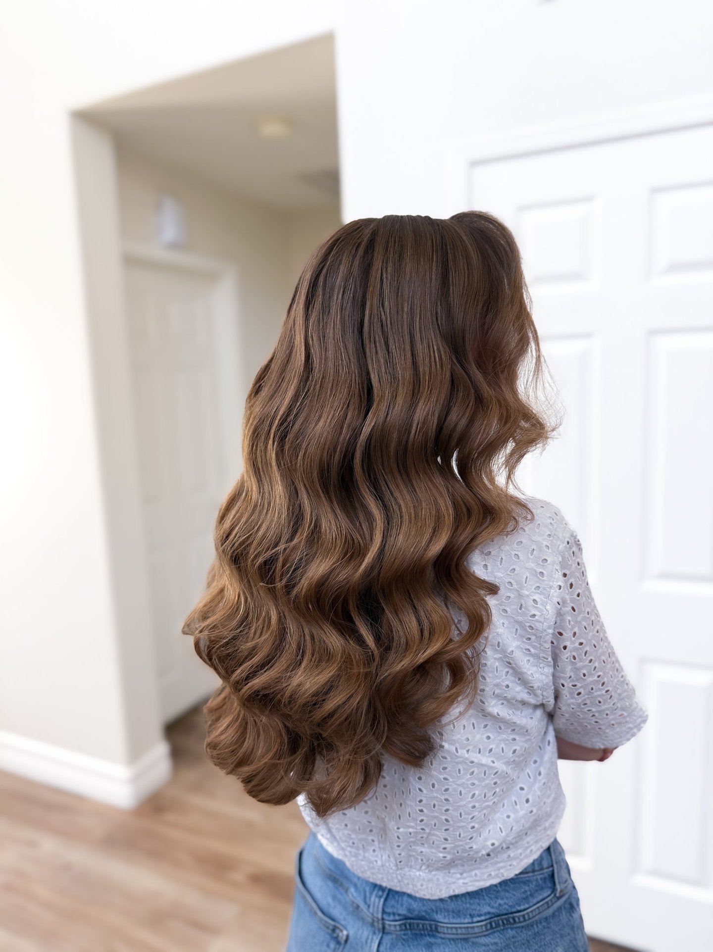Modern romantic bride in Lodi winery suite with soft waves and pinned-back style