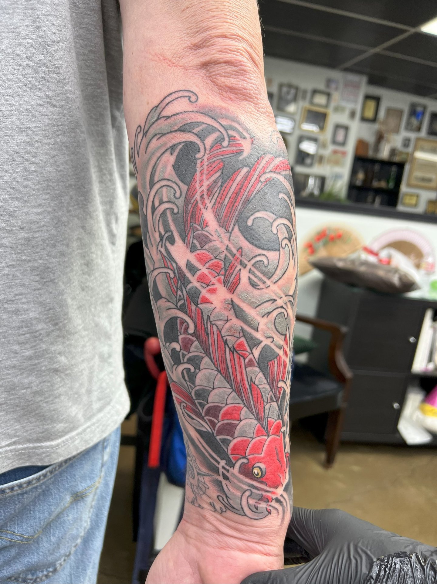 a tattoo on the arm of a man's arm koi fish color tattoo