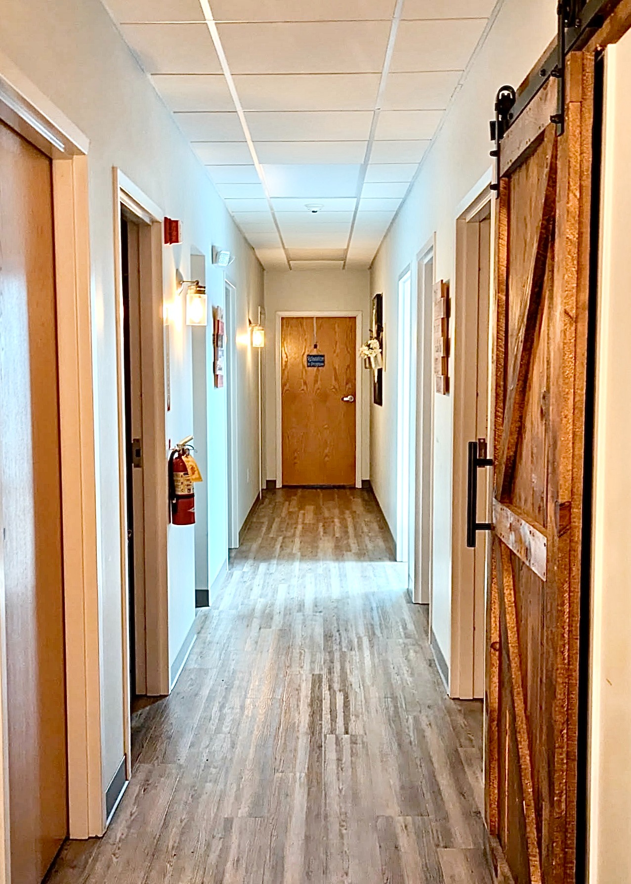 hallway corridor with multiple wooden barn doors