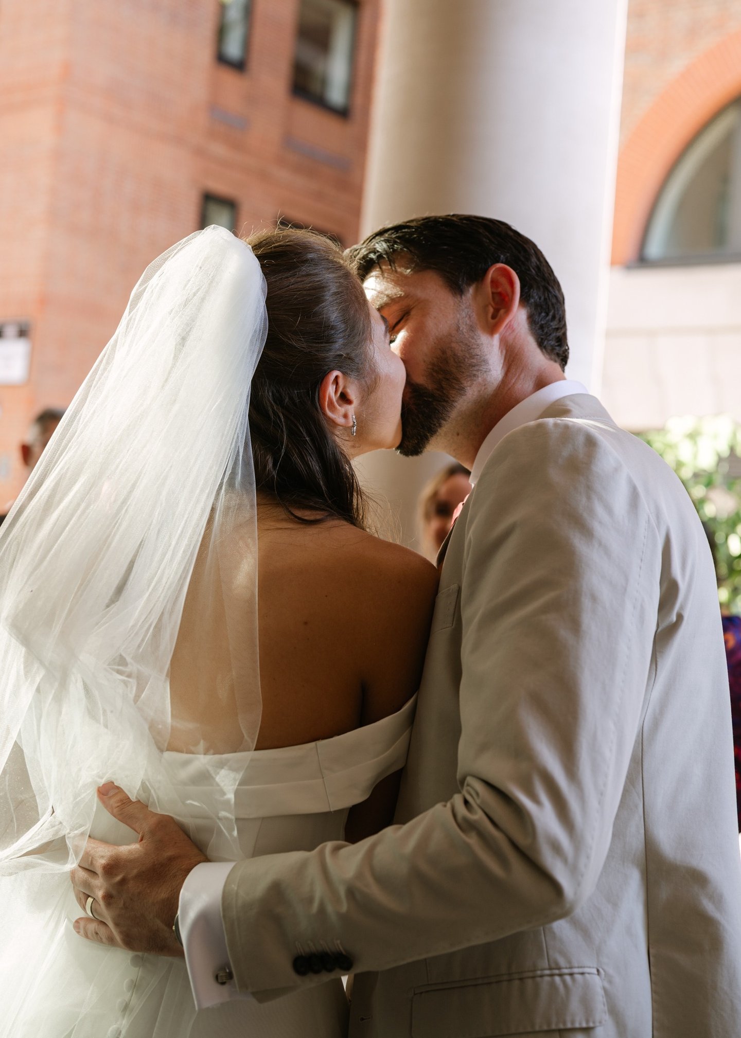 couple kissing outside of a surrey venue 