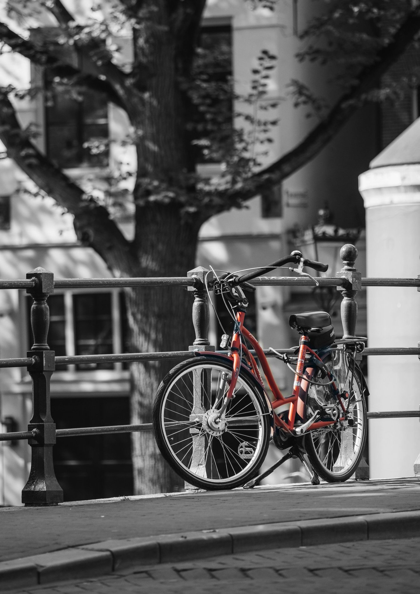 a red bicycle parked on a fence