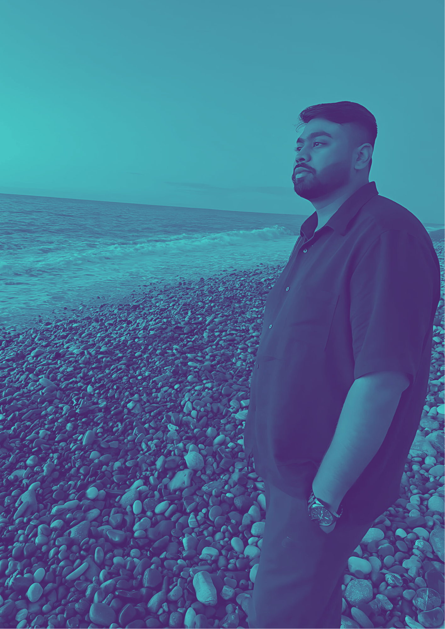 Sarang Vhankade standing on a beach around rocks