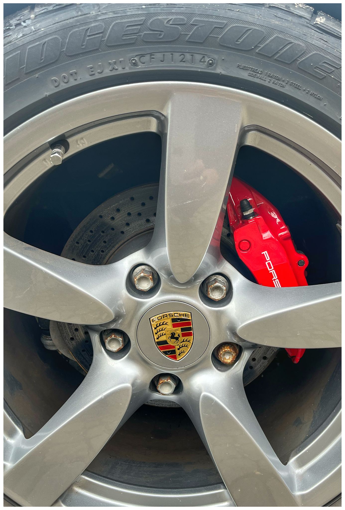 highly polished Porsche wheel with red calliper