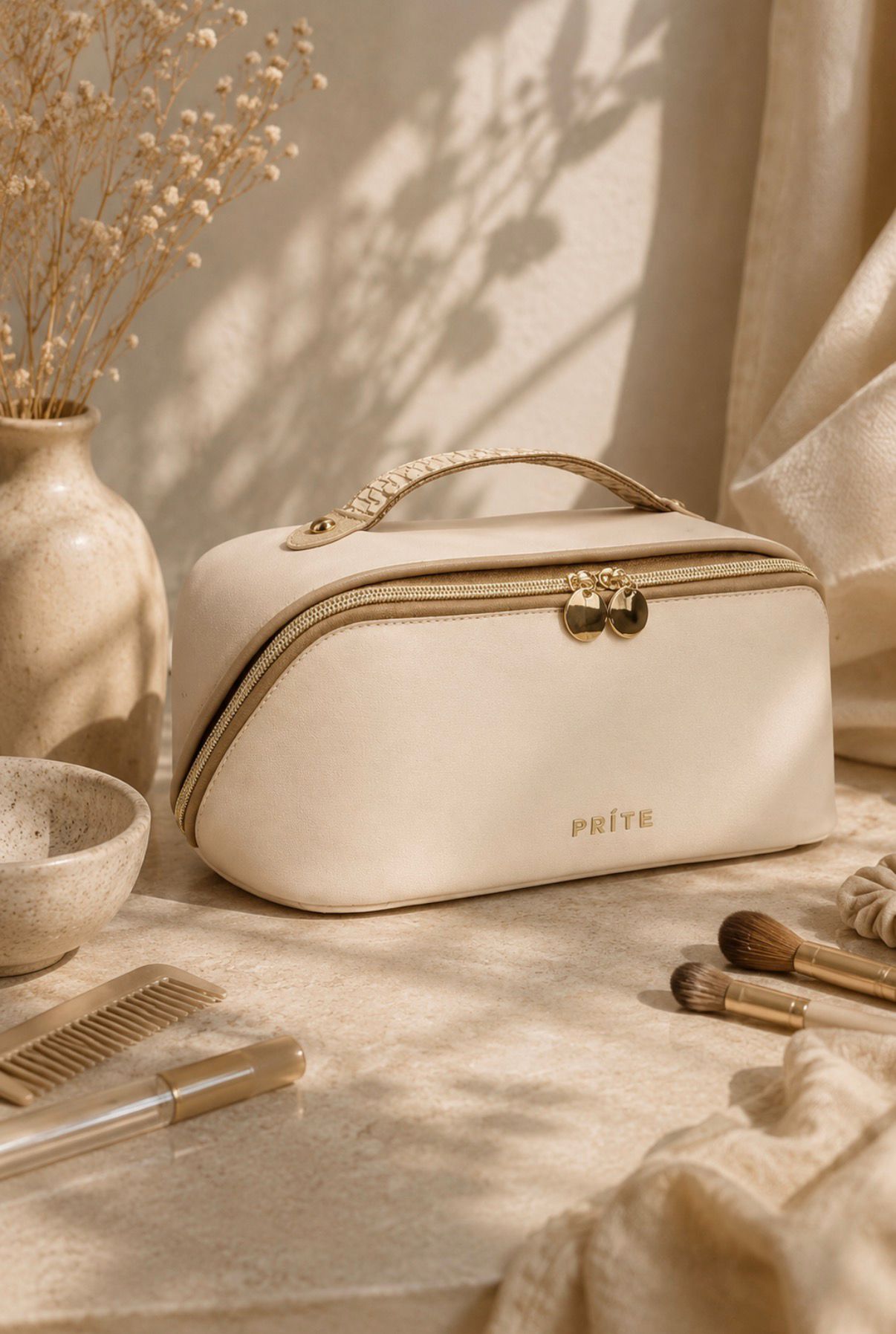 Beige makeup bag organizer with gold zipper details displayed on a neutral vanity table