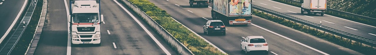 trucks and cars on a highway