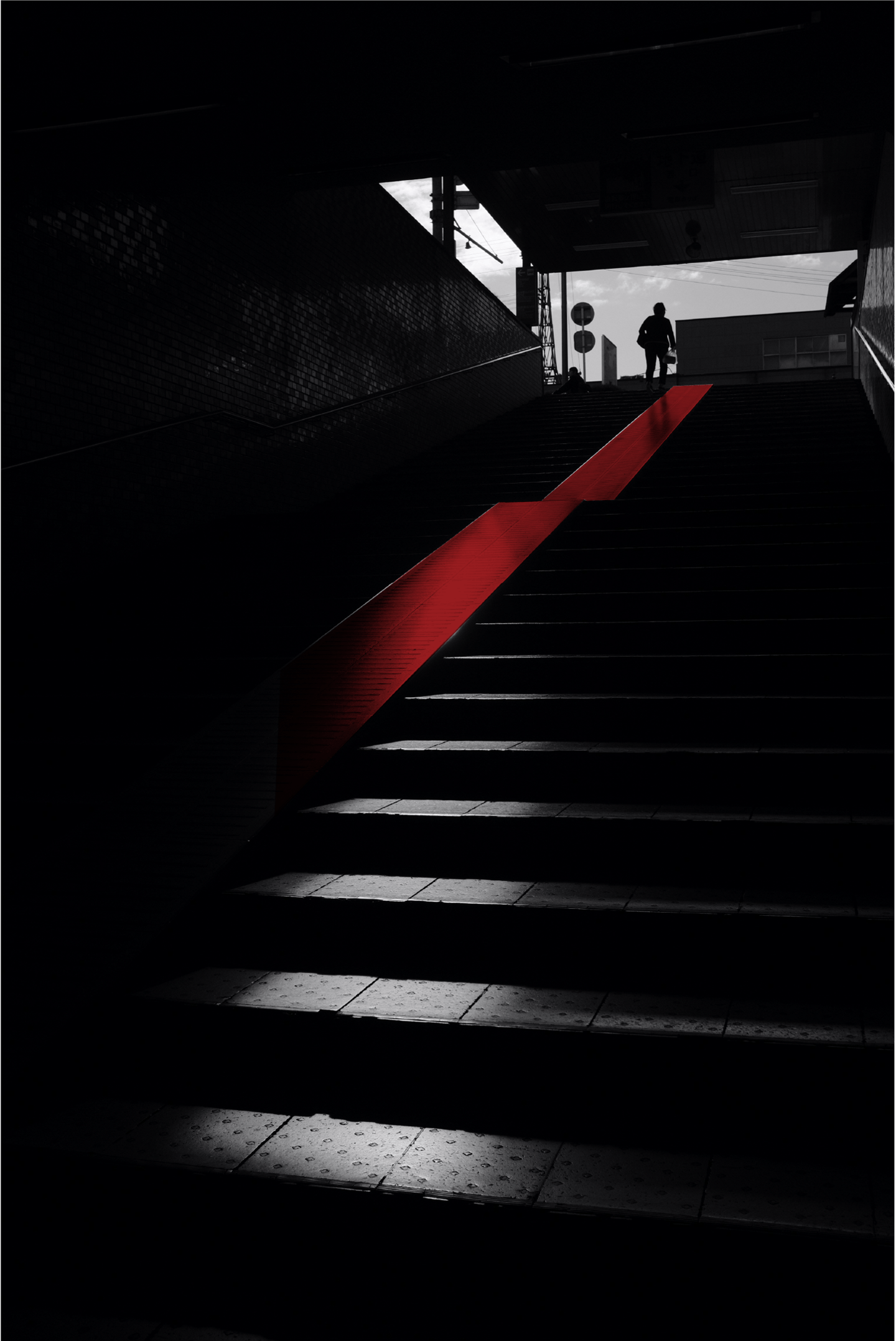 a person walking up stairs in a dark room