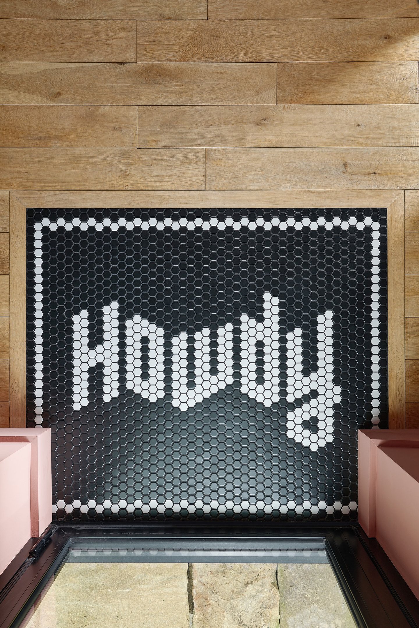 Black and white mosaic tiles with the word howdy in the design