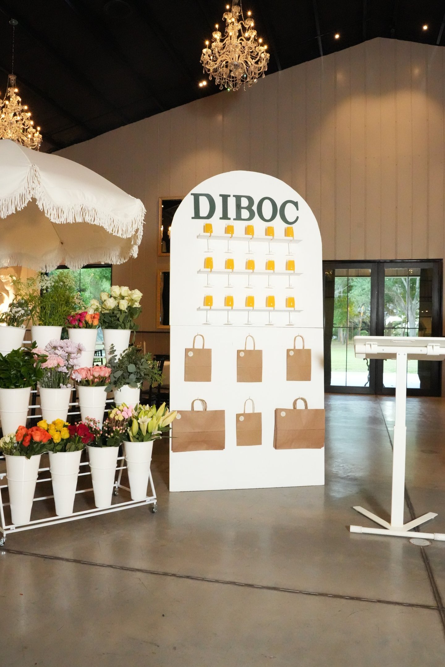 DIBOC floral & chocolate tasting display with fresh flowers and branded setup at luxury Tampa event