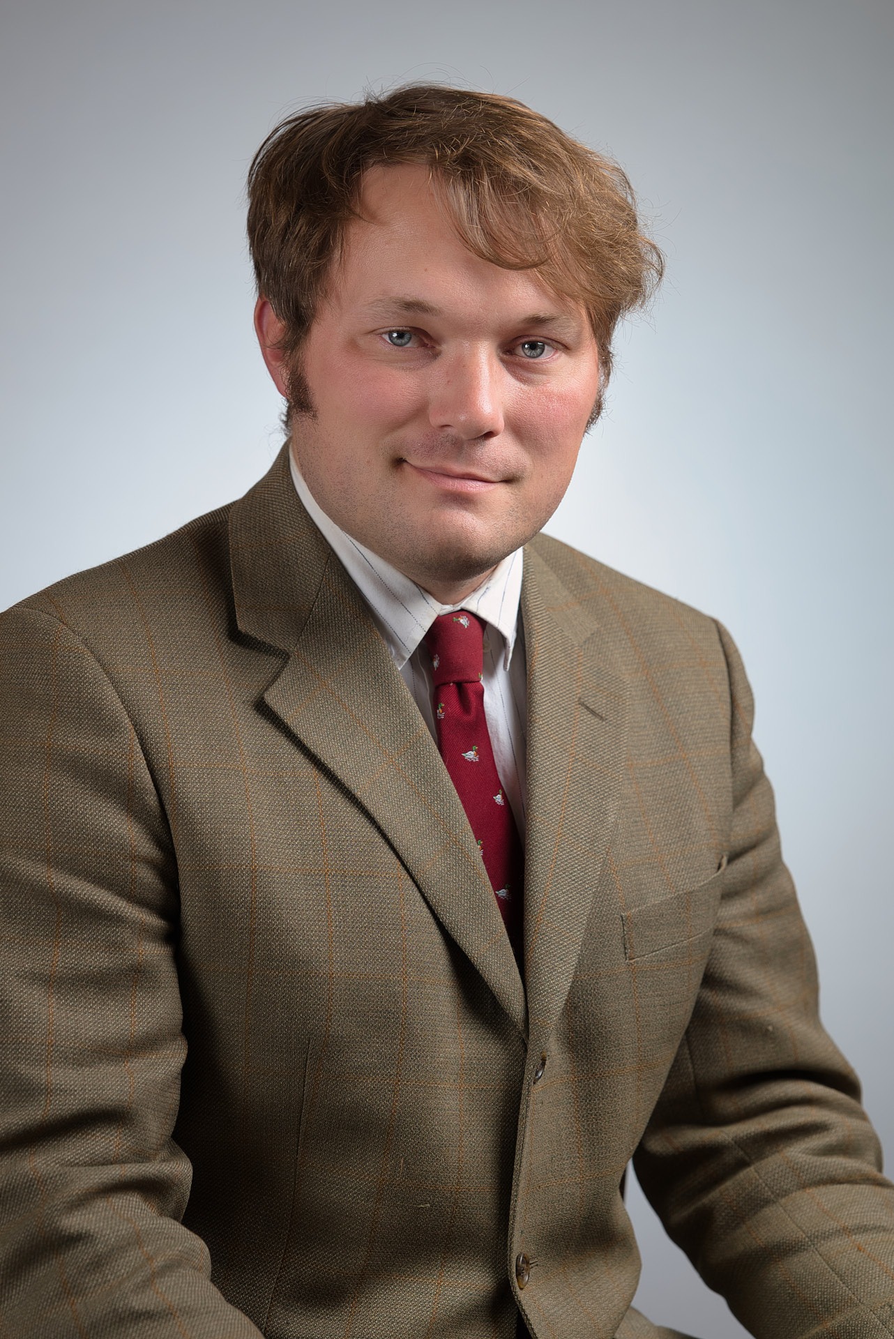 a man in a suit and a red tie and a white shirt