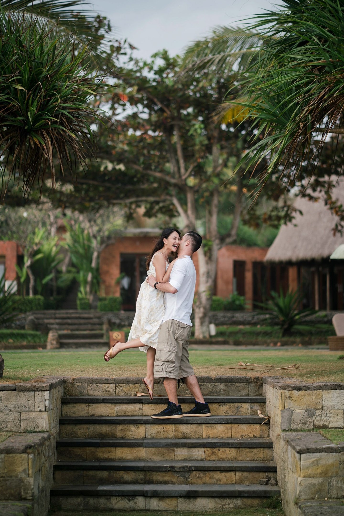 Intimate couple walking down garden steps at Waka Gangga resort in Tabanan West Bali