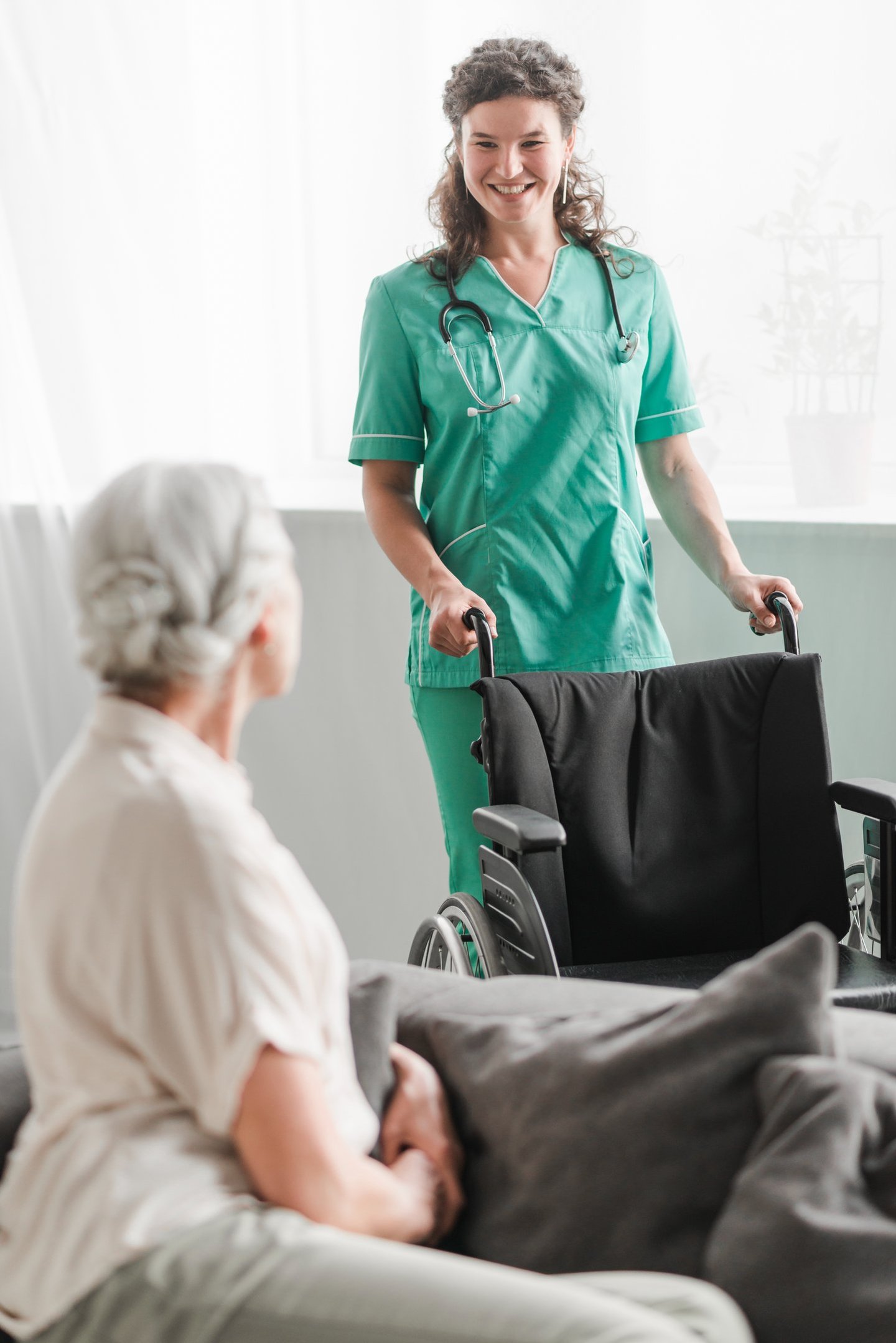a caregiver ready to help a senior woman to transfer